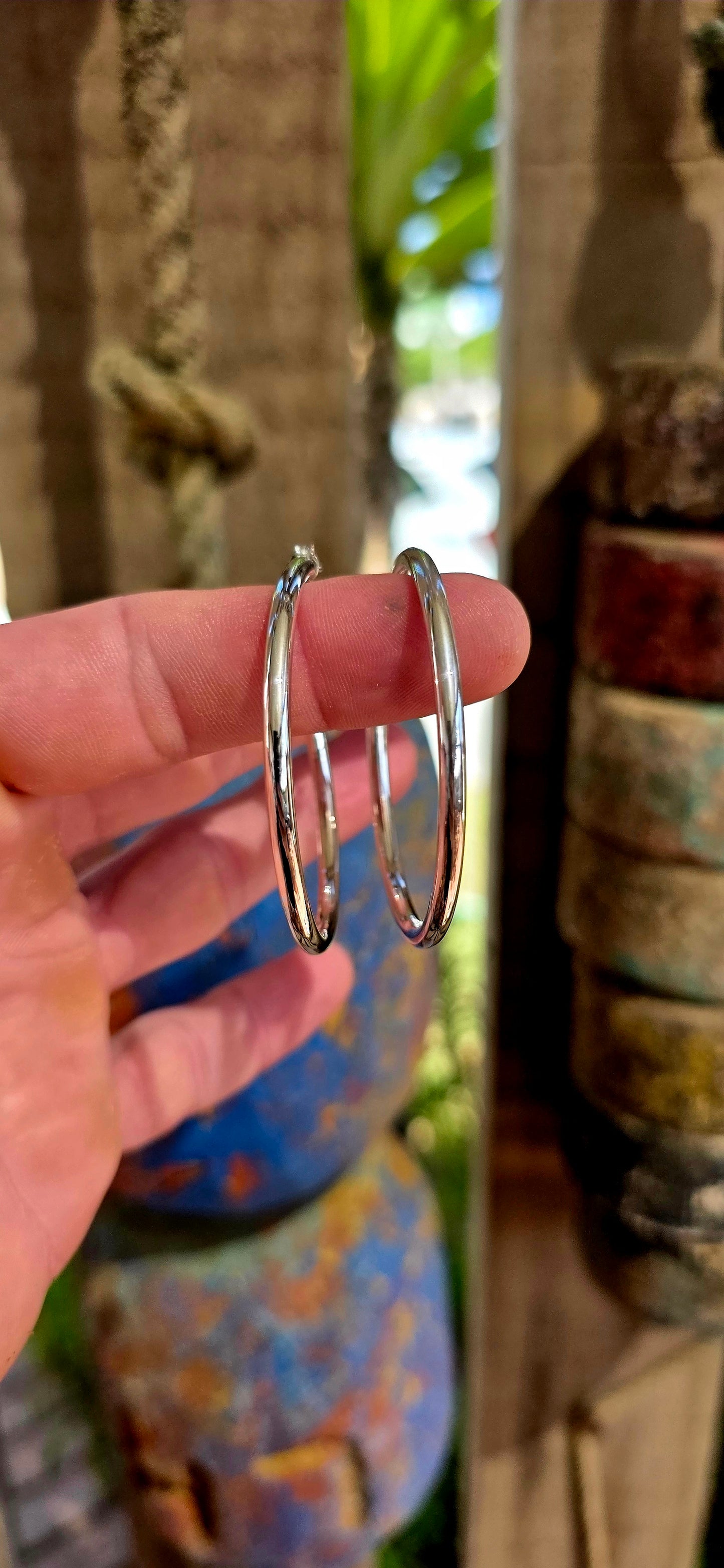 These are proper statement hoops — a generously sized pair crafted in sterling silver, designed in a classic round tubular (hollow) form that gives you that big, bold look without the heavy weight.