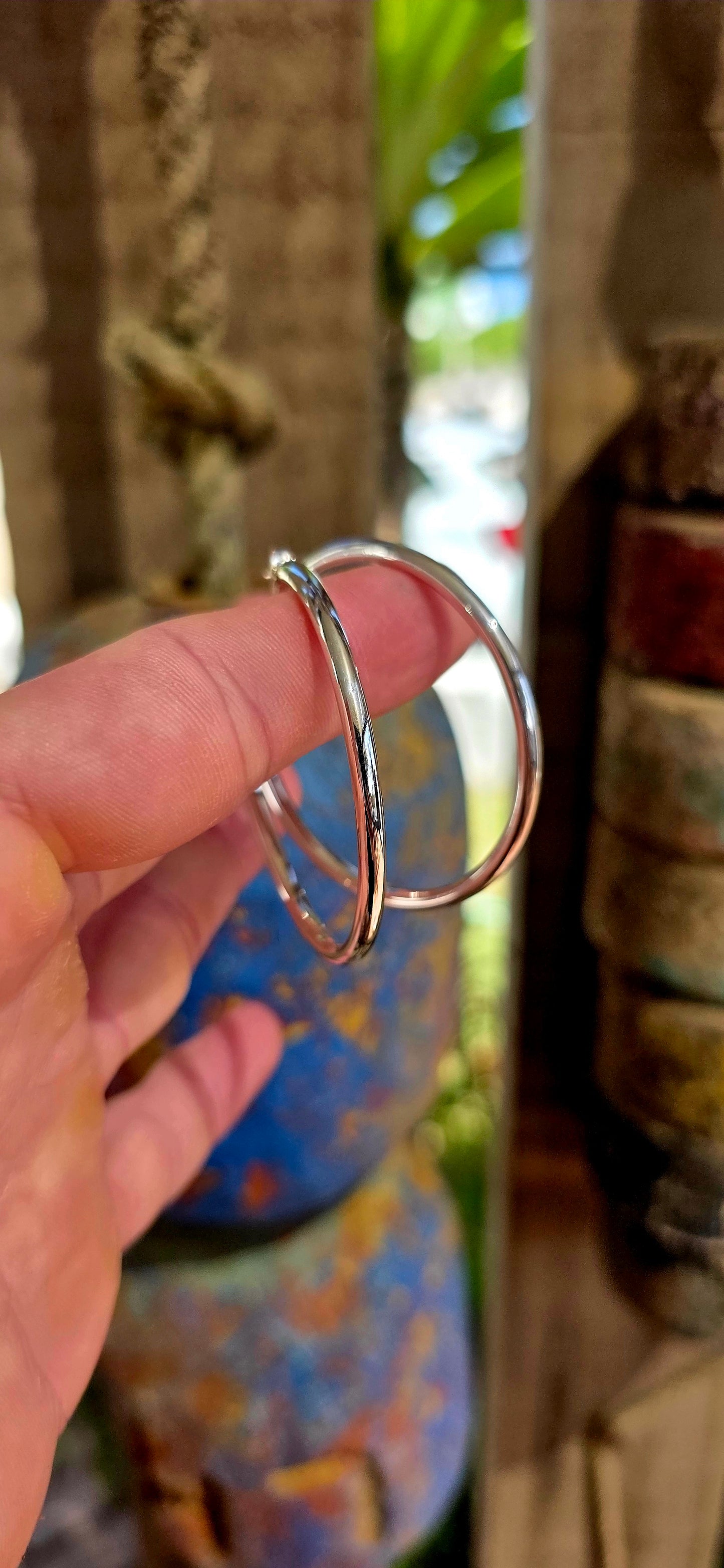 These are proper statement hoops — a generously sized pair crafted in sterling silver, designed in a classic round tubular (hollow) form that gives you that big, bold look without the heavy weight.