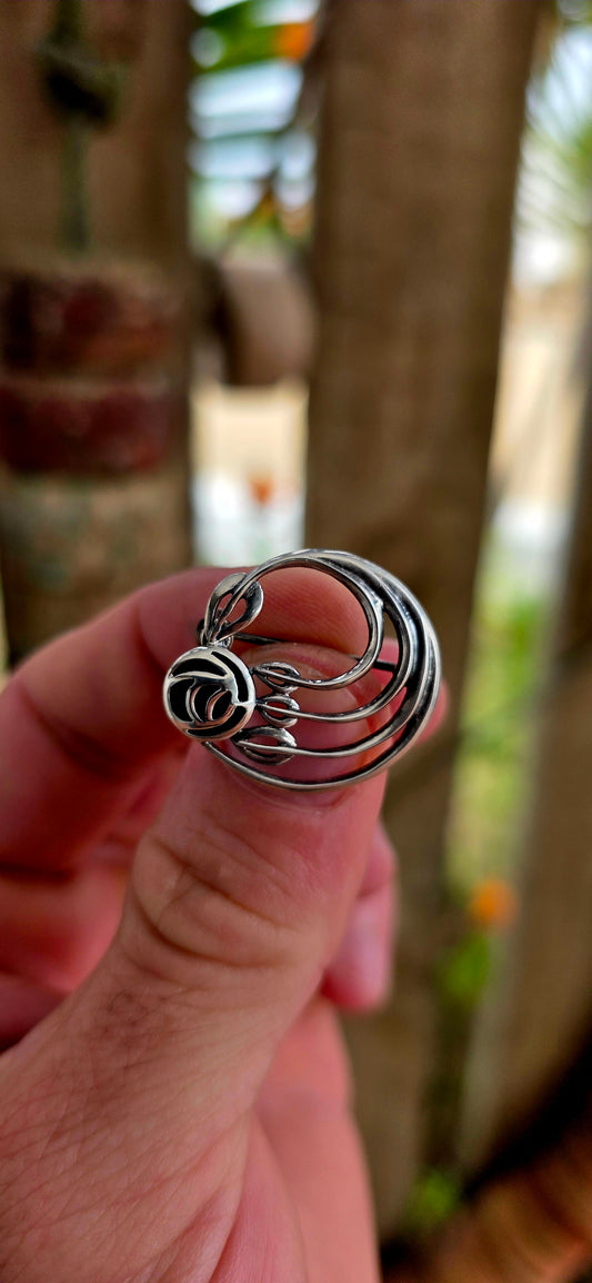 A pretty and petite vintage designer brooch, crafted in solid sterling silver and set with black onyx, created by renowned British jewellery house Kit Heath circa 1995.