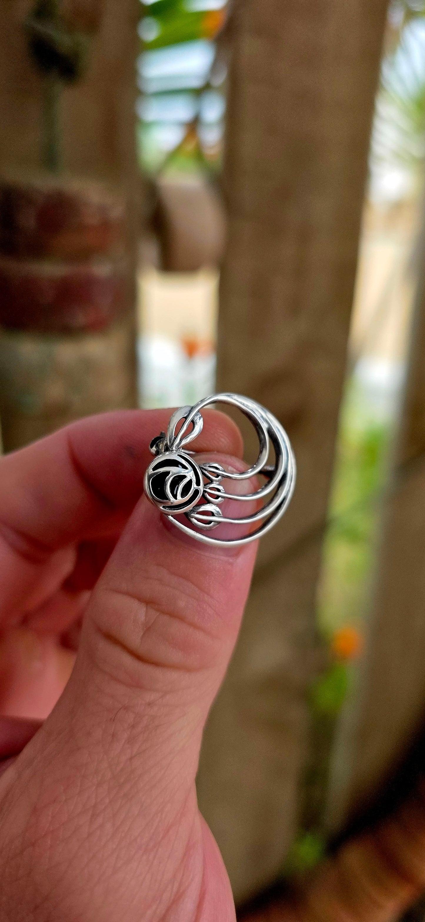 A pretty and petite vintage designer brooch, crafted in solid sterling silver and set with black onyx, created by renowned British jewellery house Kit Heath circa 1995.
