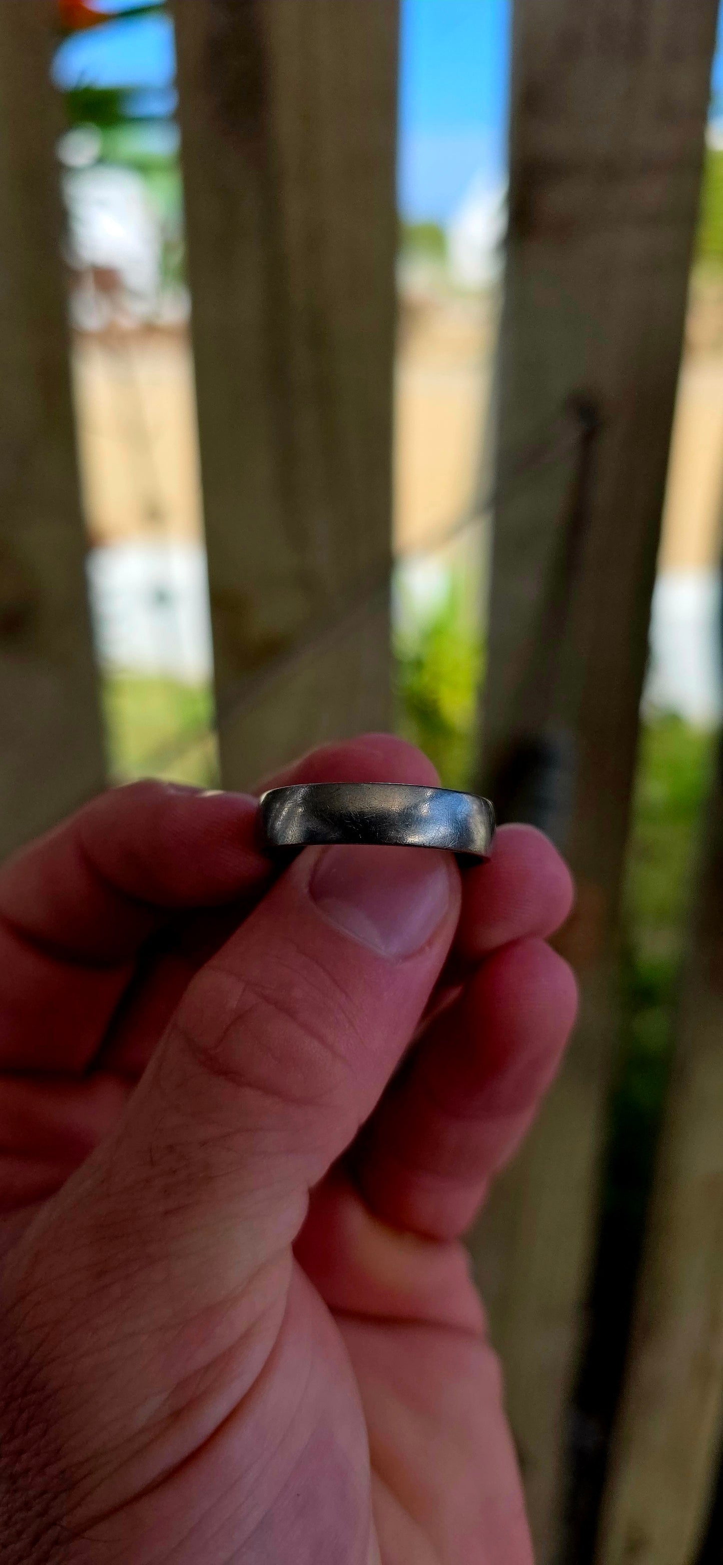A sleek, mens titanium band ring by renowned South African luxury jeweller Arthur Kaplan — the kind of piece that leans into quiet confidence and everyday power.