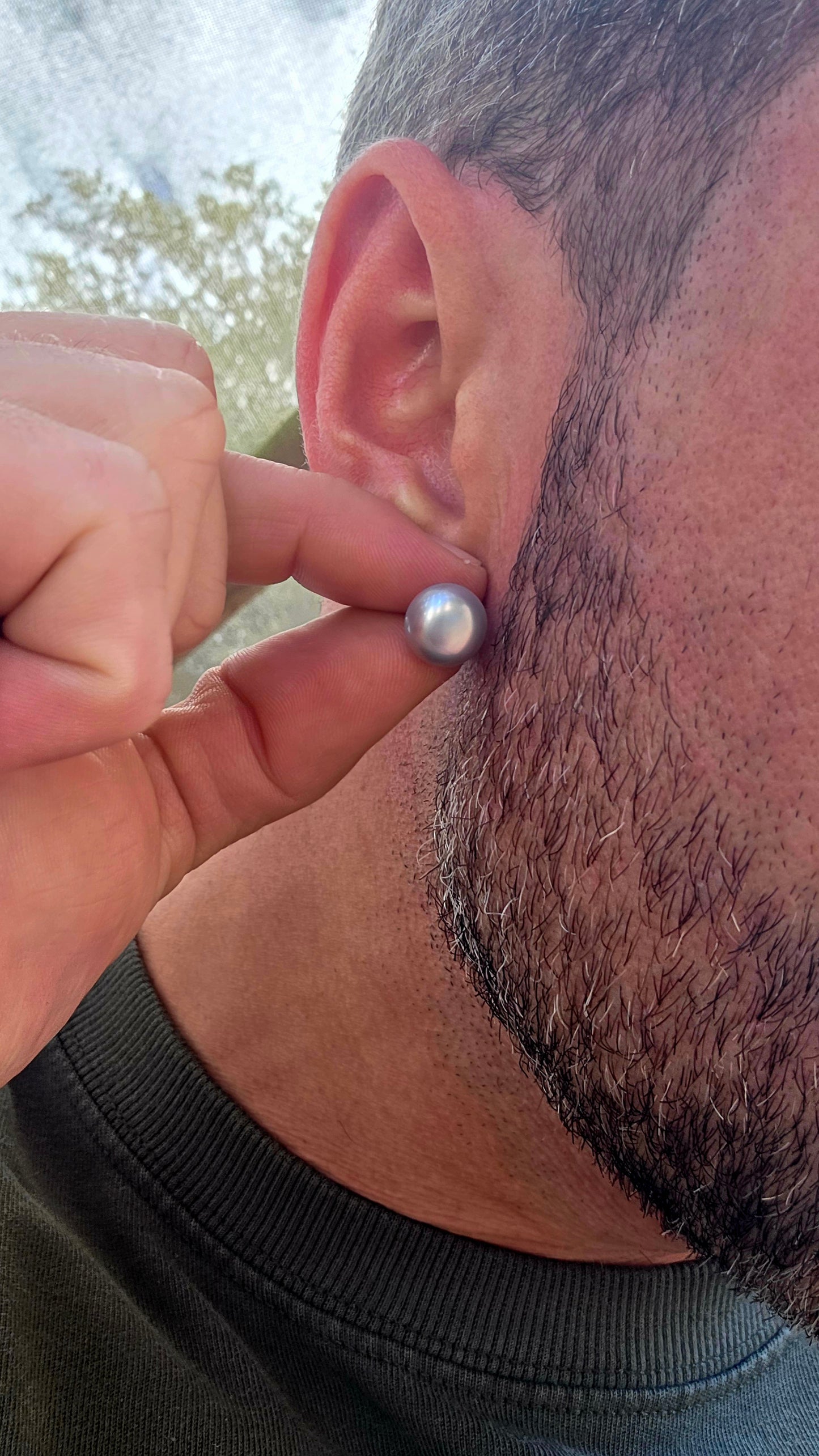 A beautiful pair of sterling silver stud earrings, each set with a smoky grey freshwater button pearl — offering a modern twist on a timeless classic.