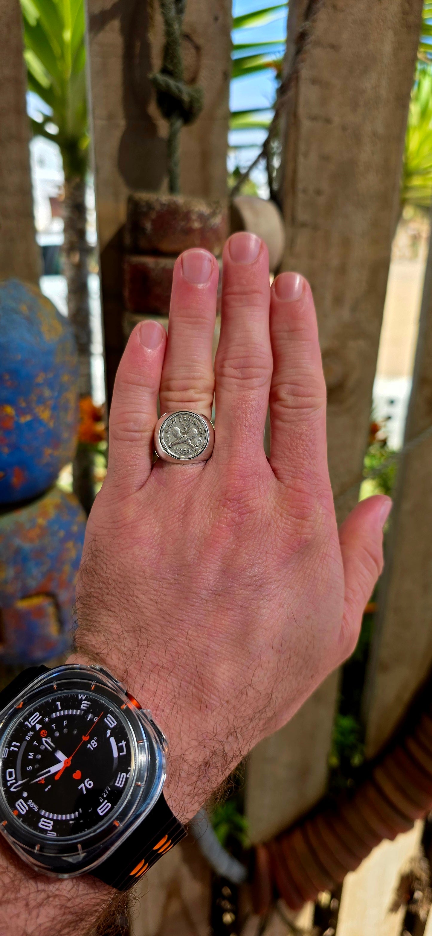 A chunky, solid sterling silver artisan-made signet ring, set with an authentic 1934 New Zealand coin featuring the classic crossed clubs motif.