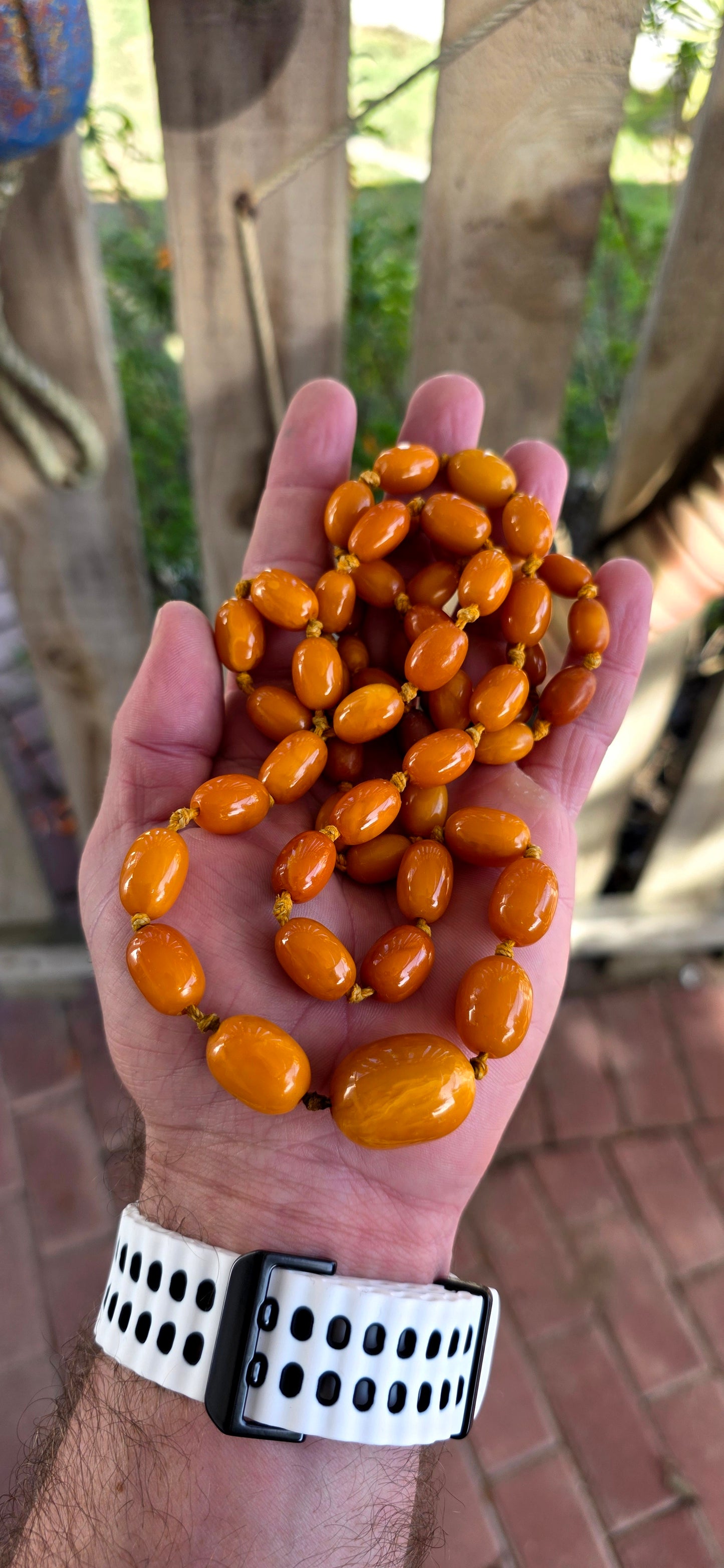 An extra-length antique Baltic amber necklace, showcasing a luxurious strand of butterscotch amber beads in beautifully graduated oval forms.