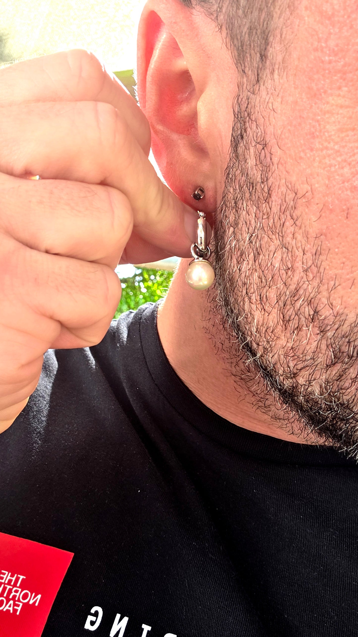 A beautiful pair of sterling silver huggie/hoop earrings, each fitted with removable shell pearl dangles — giving you two looks in one