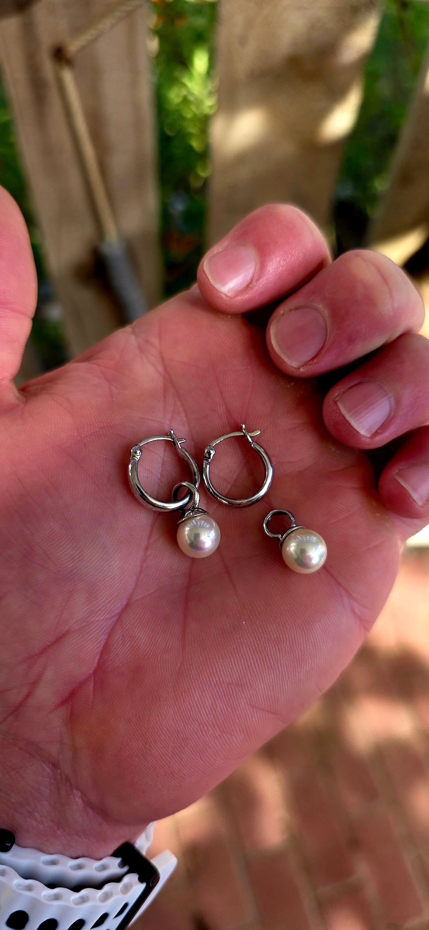 A beautiful pair of sterling silver huggie/hoop earrings, each fitted with removable shell pearl dangles — giving you two looks in one