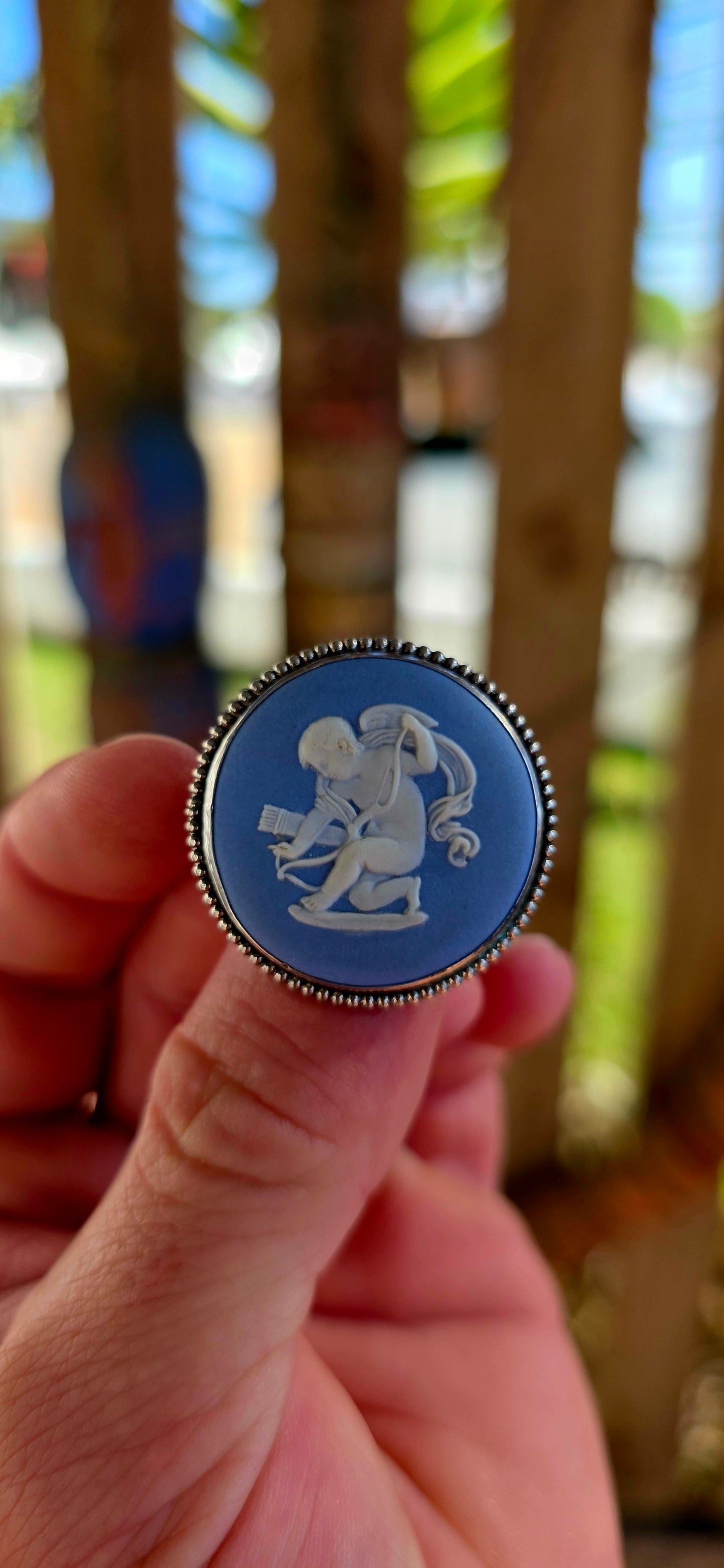 A beautiful vintage sterling silver and Wedgwood jasperware brooch, featuring a classic baby blue jasperware panel adorned with a finely detailed white embossed cherub.