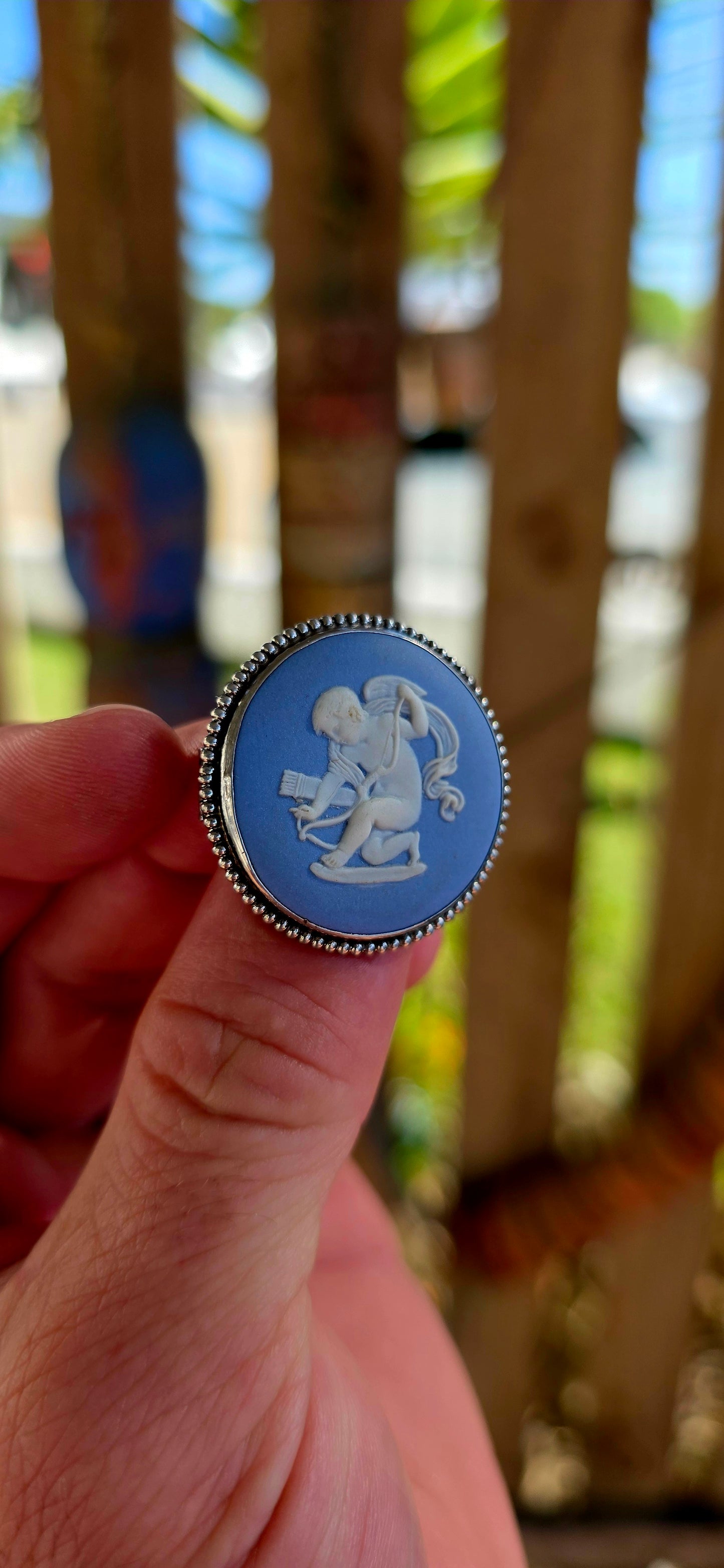 A beautiful vintage sterling silver and Wedgwood jasperware brooch, featuring a classic baby blue jasperware panel adorned with a finely detailed white embossed cherub.
