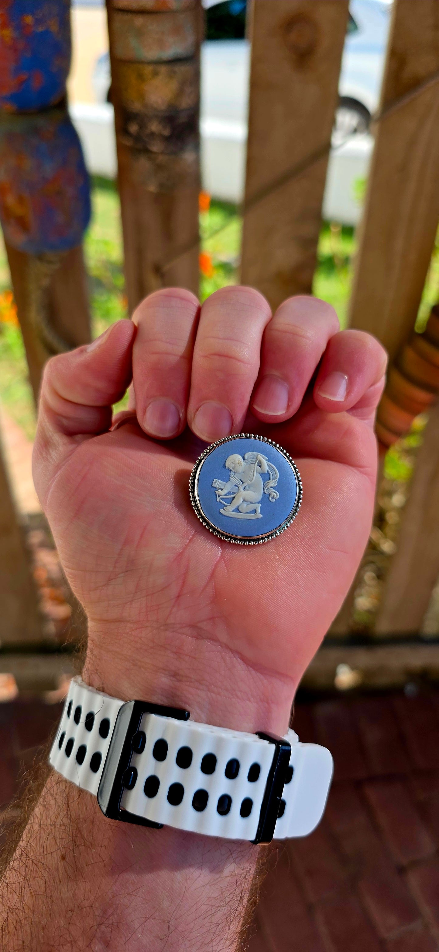 A beautiful vintage sterling silver and Wedgwood jasperware brooch, featuring a classic baby blue jasperware panel adorned with a finely detailed white embossed cherub.