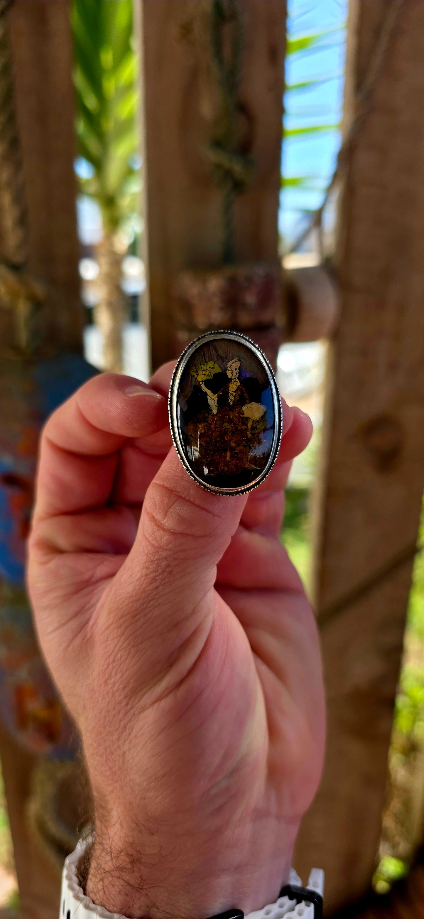 A vintage early 1900s English sterling silver portrait brooch, featuring a beautifully detailed Victorian-era lady captured beneath a domed glass cabochon.