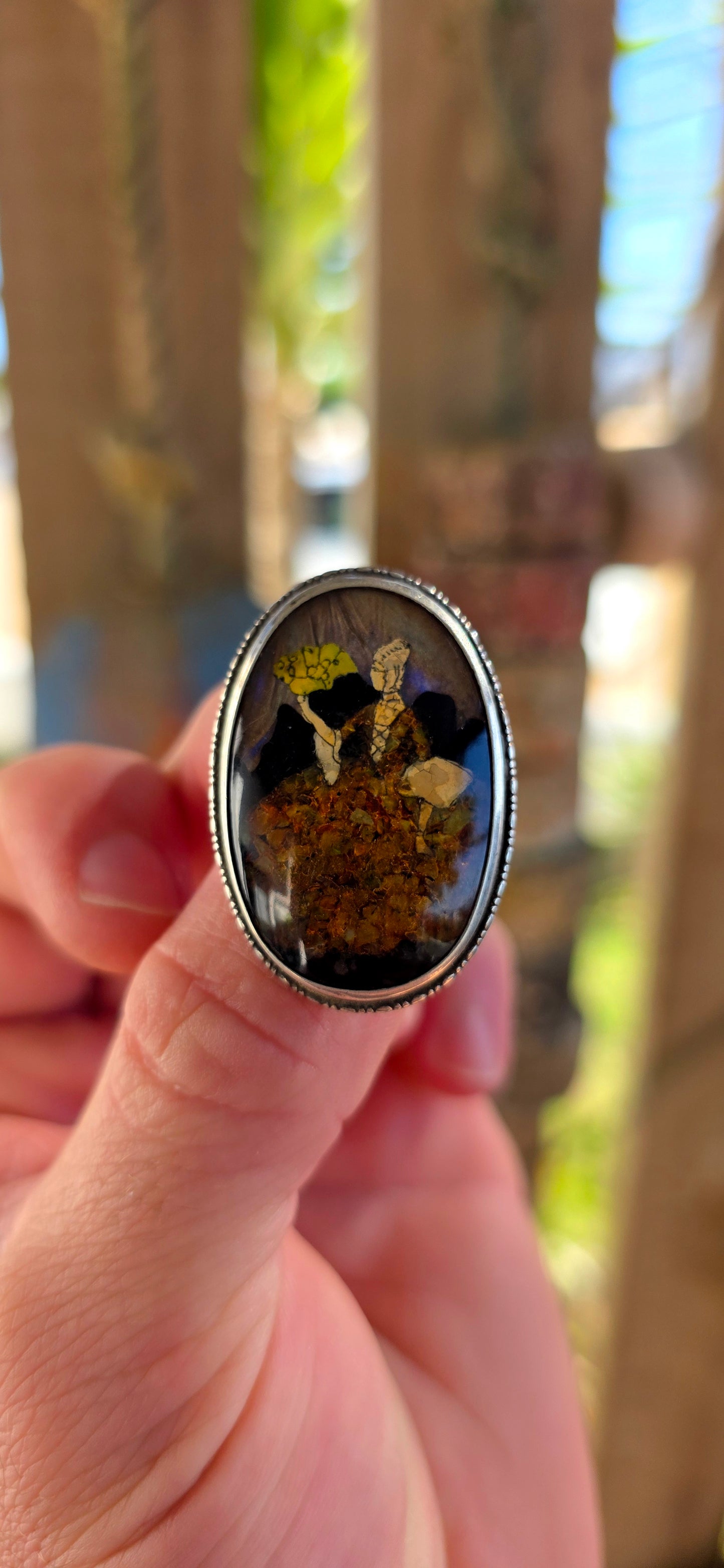 A vintage early 1900s English sterling silver portrait brooch, featuring a beautifully detailed Victorian-era lady captured beneath a domed glass cabochon.
