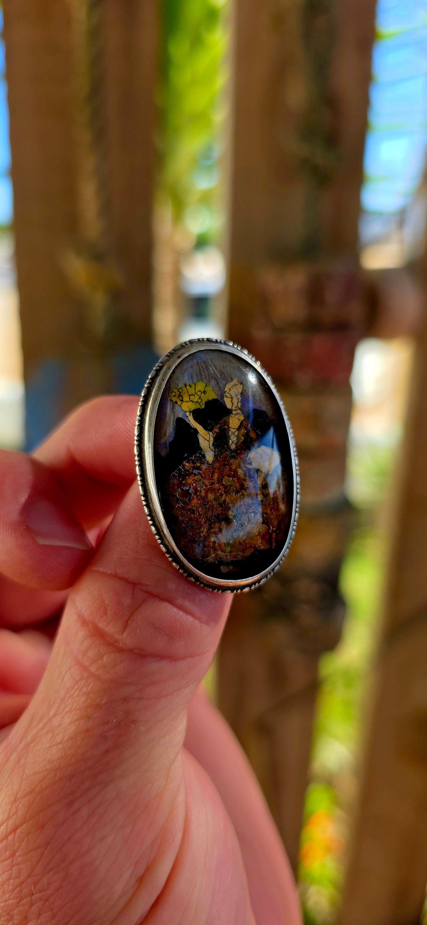 A vintage early 1900s English sterling silver portrait brooch, featuring a beautifully detailed Victorian-era lady captured beneath a domed glass cabochon.