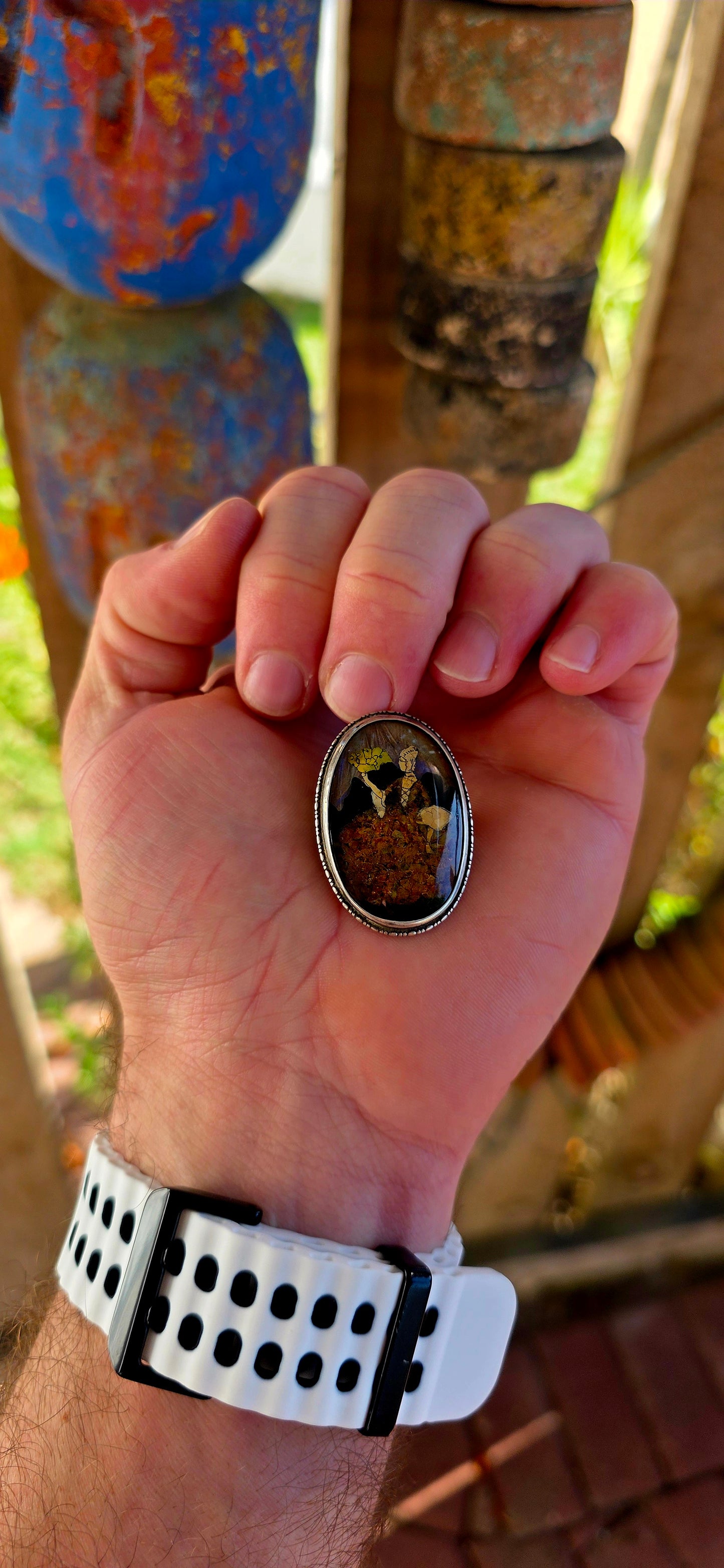 A vintage early 1900s English sterling silver portrait brooch, featuring a beautifully detailed Victorian-era lady captured beneath a domed glass cabochon.