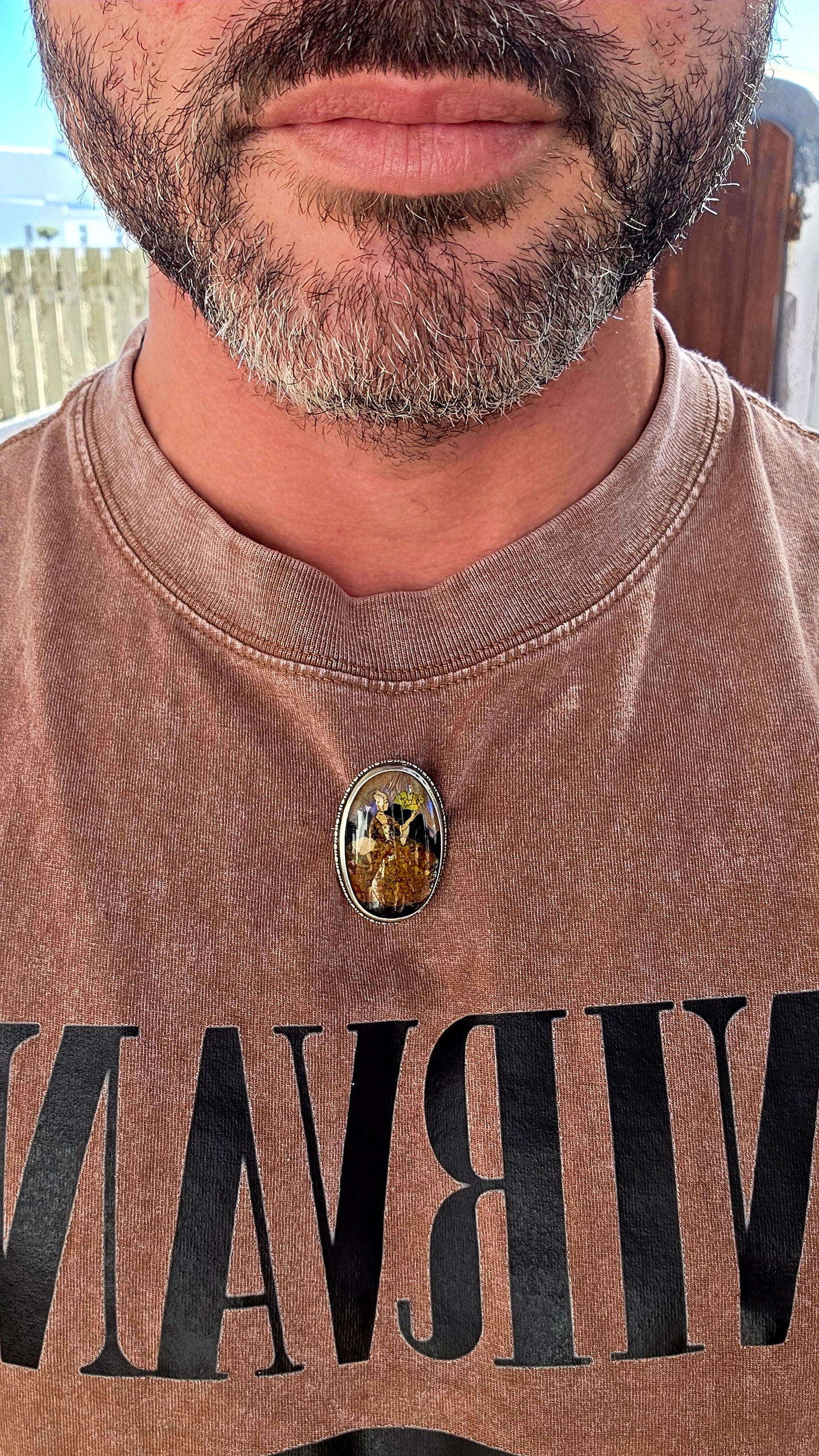 A vintage early 1900s English sterling silver portrait brooch, featuring a beautifully detailed Victorian-era lady captured beneath a domed glass cabochon.