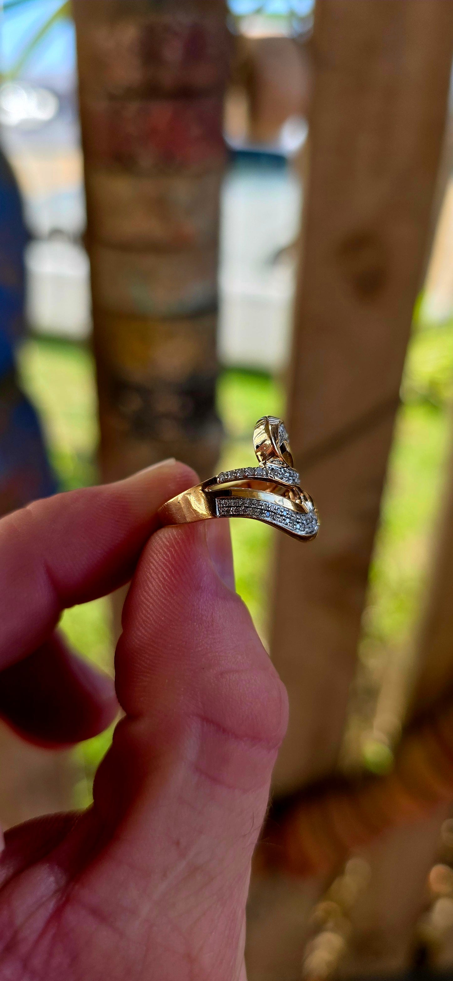 A striking modernist 9ct yellow gold dress ring, crafted in a bold passover / bypass (“toi et moi”) design, where two flowing forms curve gracefully around one another — symbolising two souls meeting and intertwining.