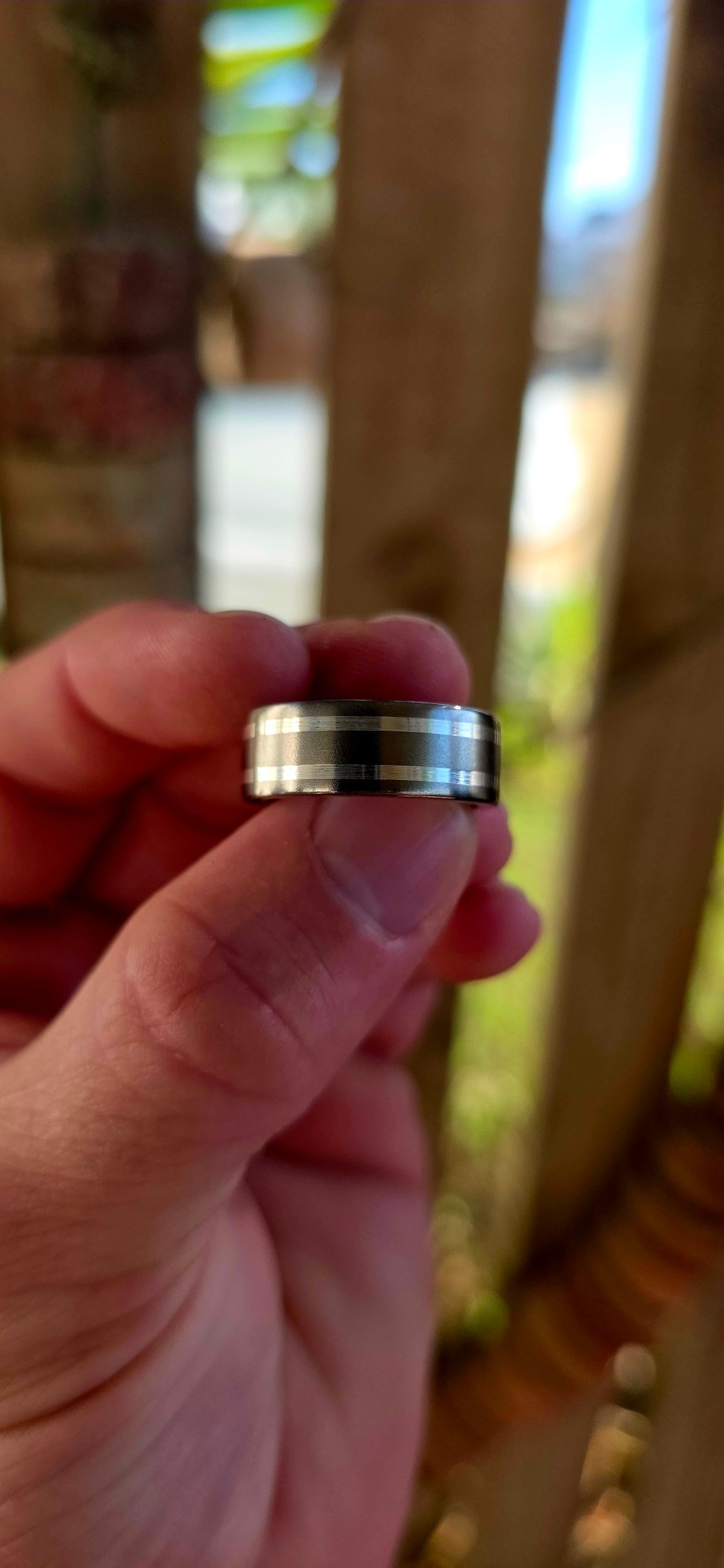 An artisan-crafted titanium and sterling silver ring, designed in a timeless D-shaped band that sits comfortably on the finger with that perfect solid feel.