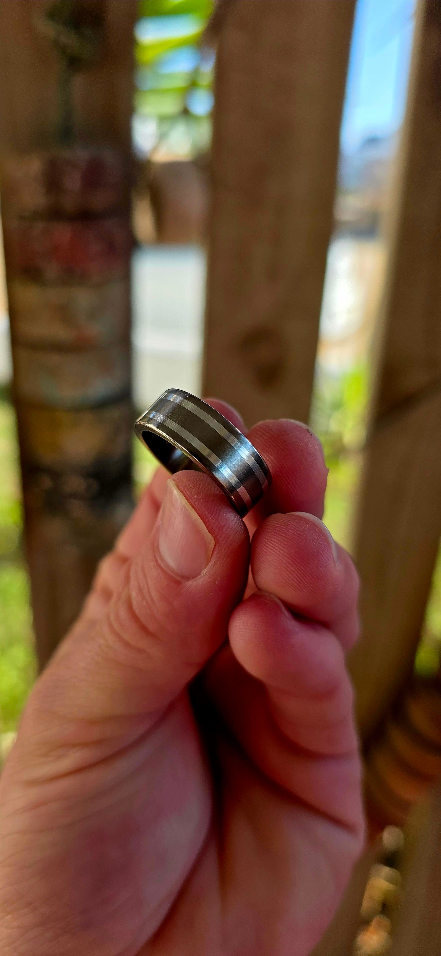 An artisan-crafted titanium and sterling silver ring, designed in a timeless D-shaped band that sits comfortably on the finger with that perfect solid feel.