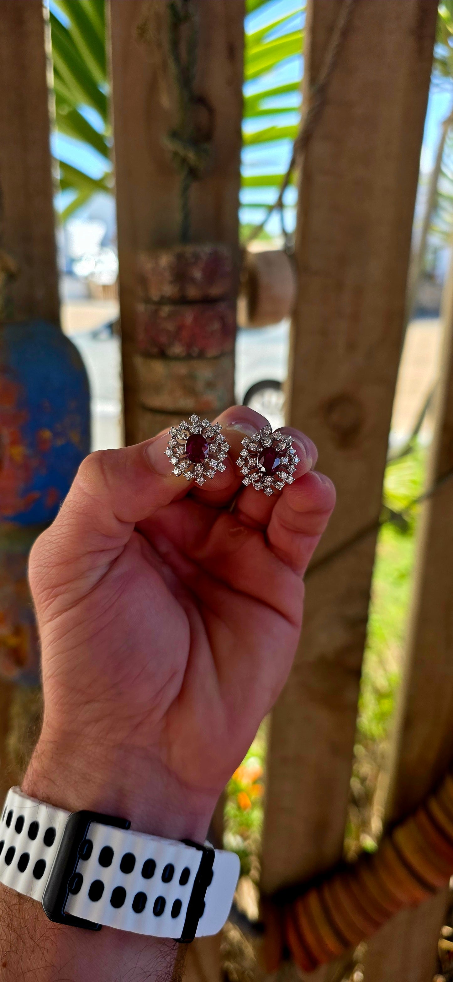 A striking pair of sterling silver starburst cluster earrings, designed to command attention from every angle. At the heart of each earring sits a rich oval-cut ruby, prong-set to let that deep, romantic red glow through beautifully.