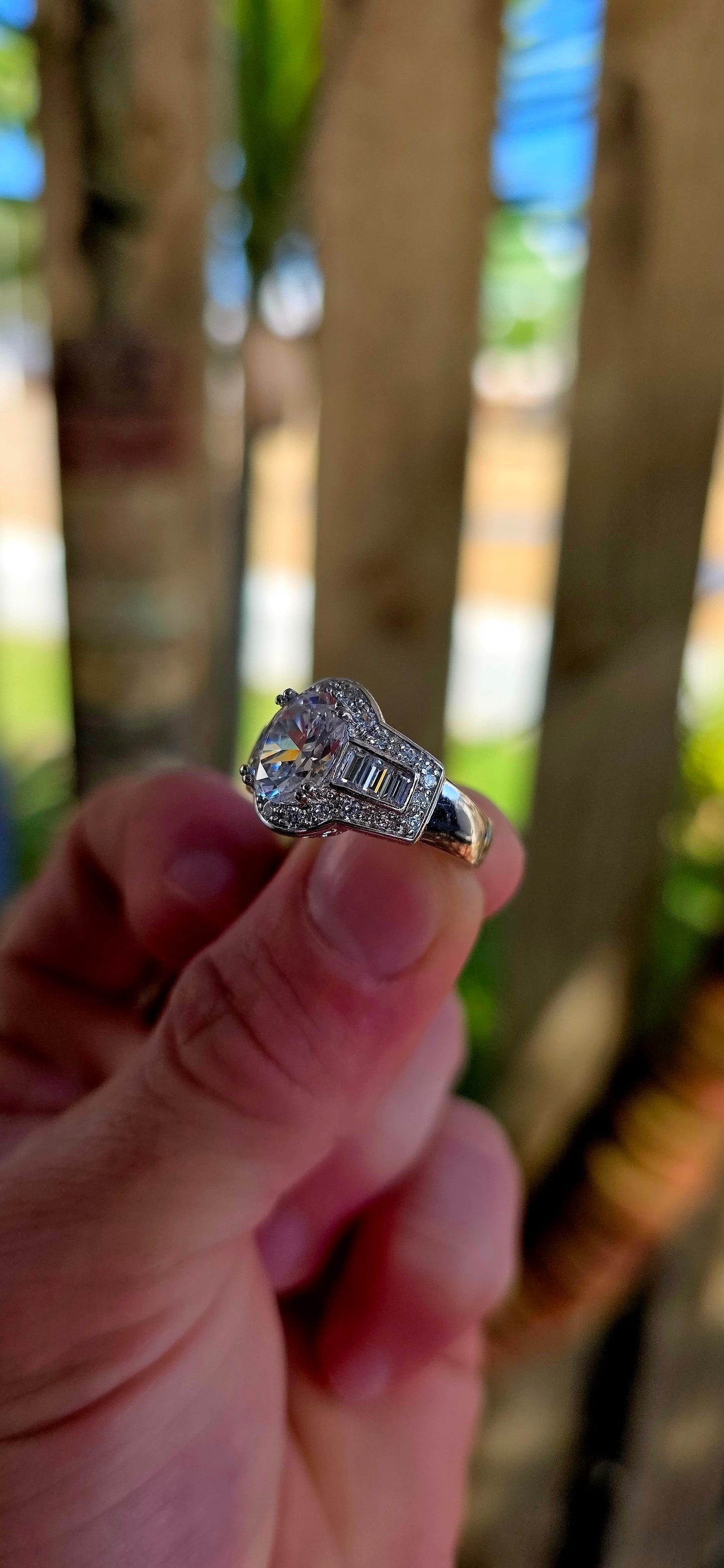 A high-quality designer-crafted sterling silver dress ring, set with a large oval-cut cubic zirconia at the centre, elevated in elegant prong settings to maximise light and sparkle.