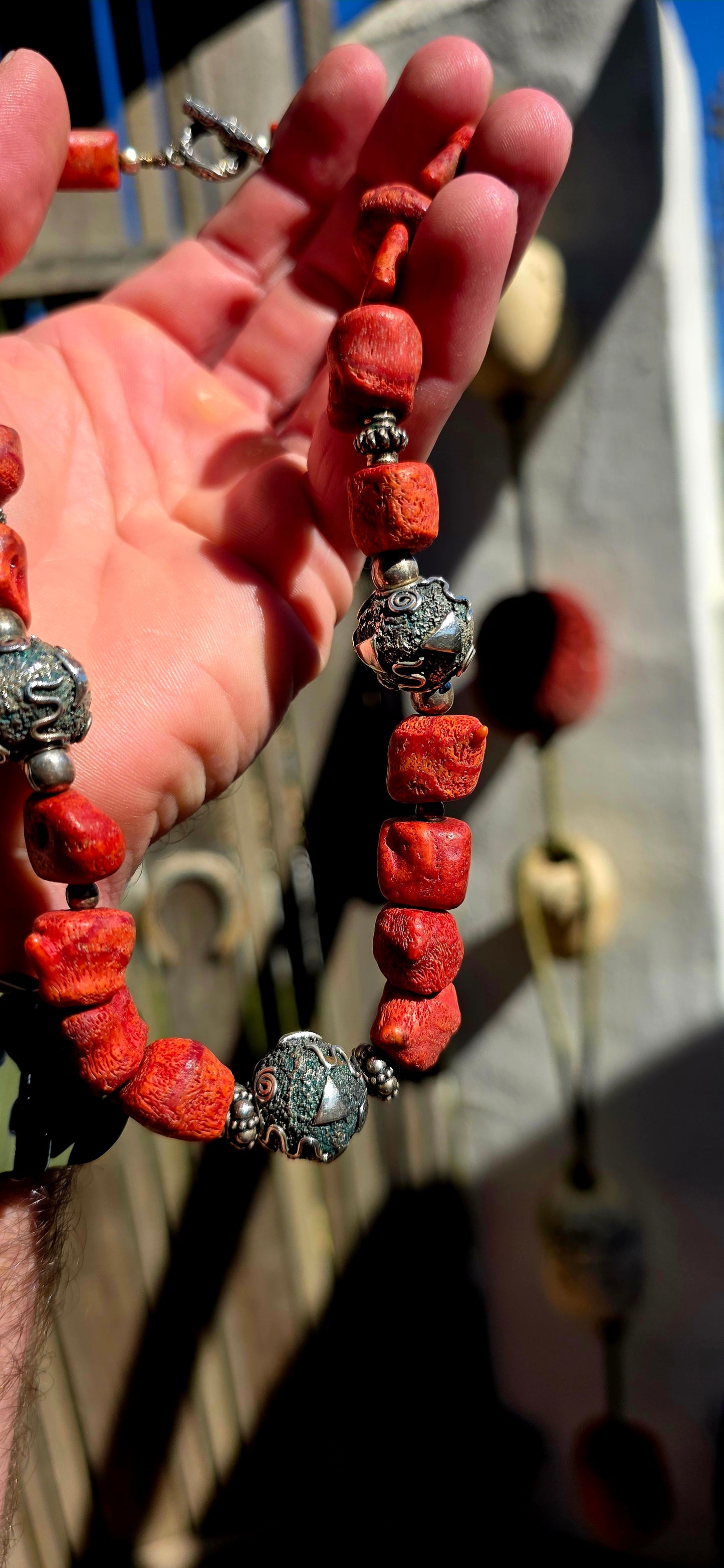 This chunky artisan-made necklace is crafted in solid sterling silver and strung with beautifully irregular, semi-polished natural Mediterranean coral beads.
