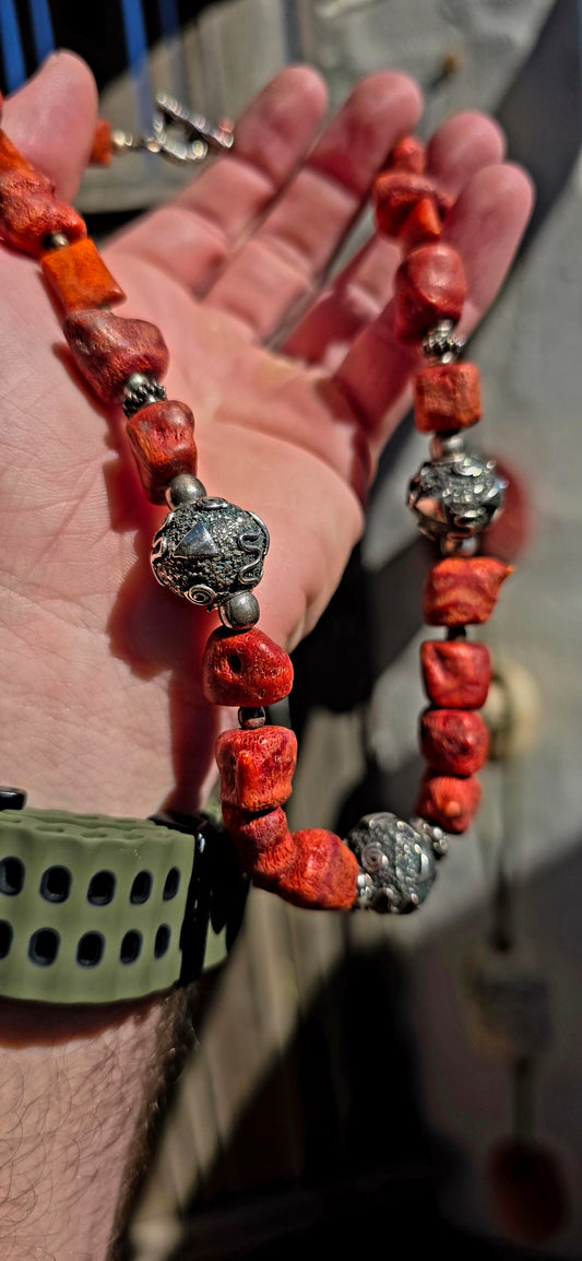 This chunky artisan-made necklace is crafted in solid sterling silver and strung with beautifully irregular, semi-polished natural Mediterranean coral beads.