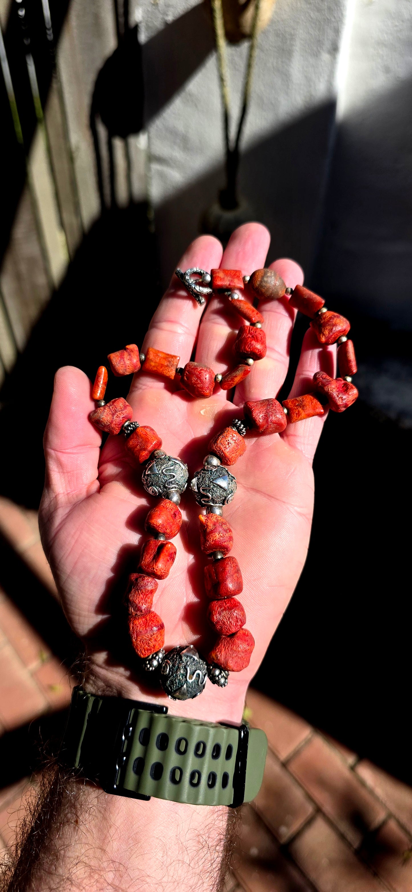 This chunky artisan-made necklace is crafted in solid sterling silver and strung with beautifully irregular, semi-polished natural Mediterranean coral beads.