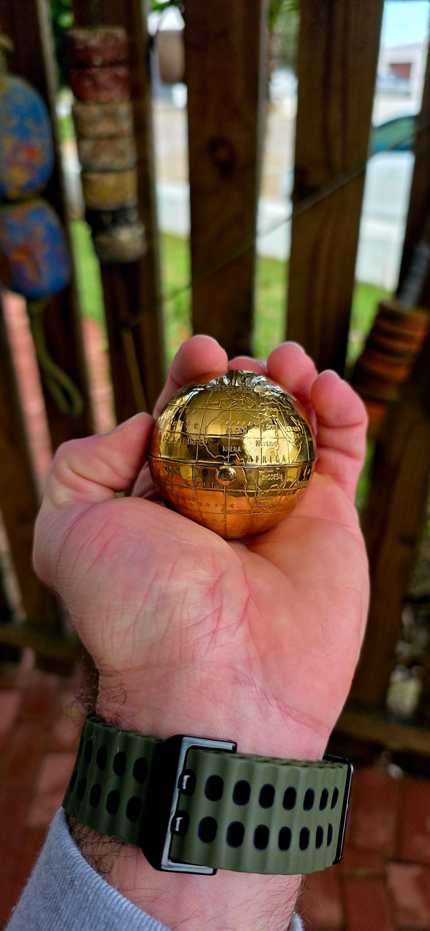 A wildly charming and highly sought-after mid-century novelty compact, beautifully crafted in warm golden brass — and shaped as a miniature world globe.