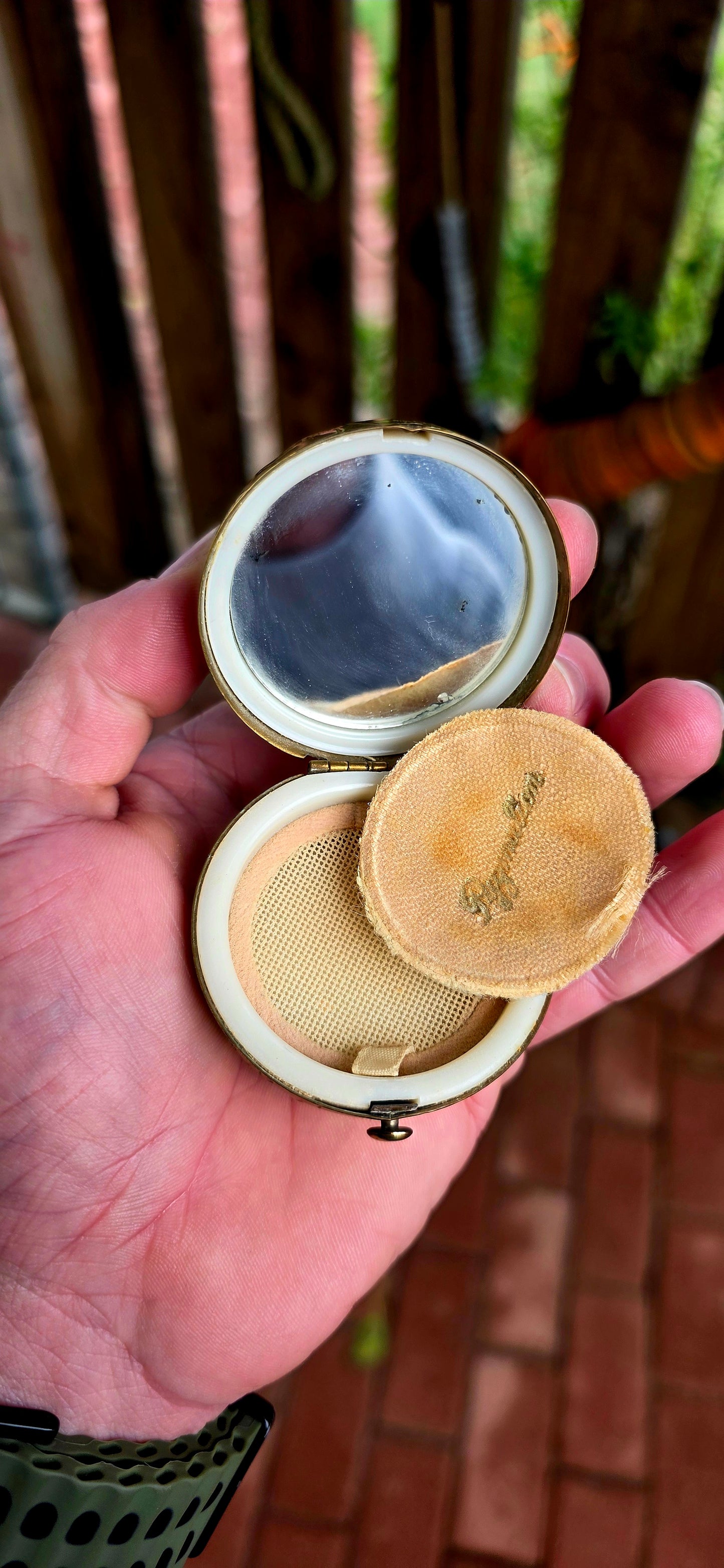 A wildly charming and highly sought-after mid-century novelty compact, beautifully crafted in warm golden brass — and shaped as a miniature world globe.