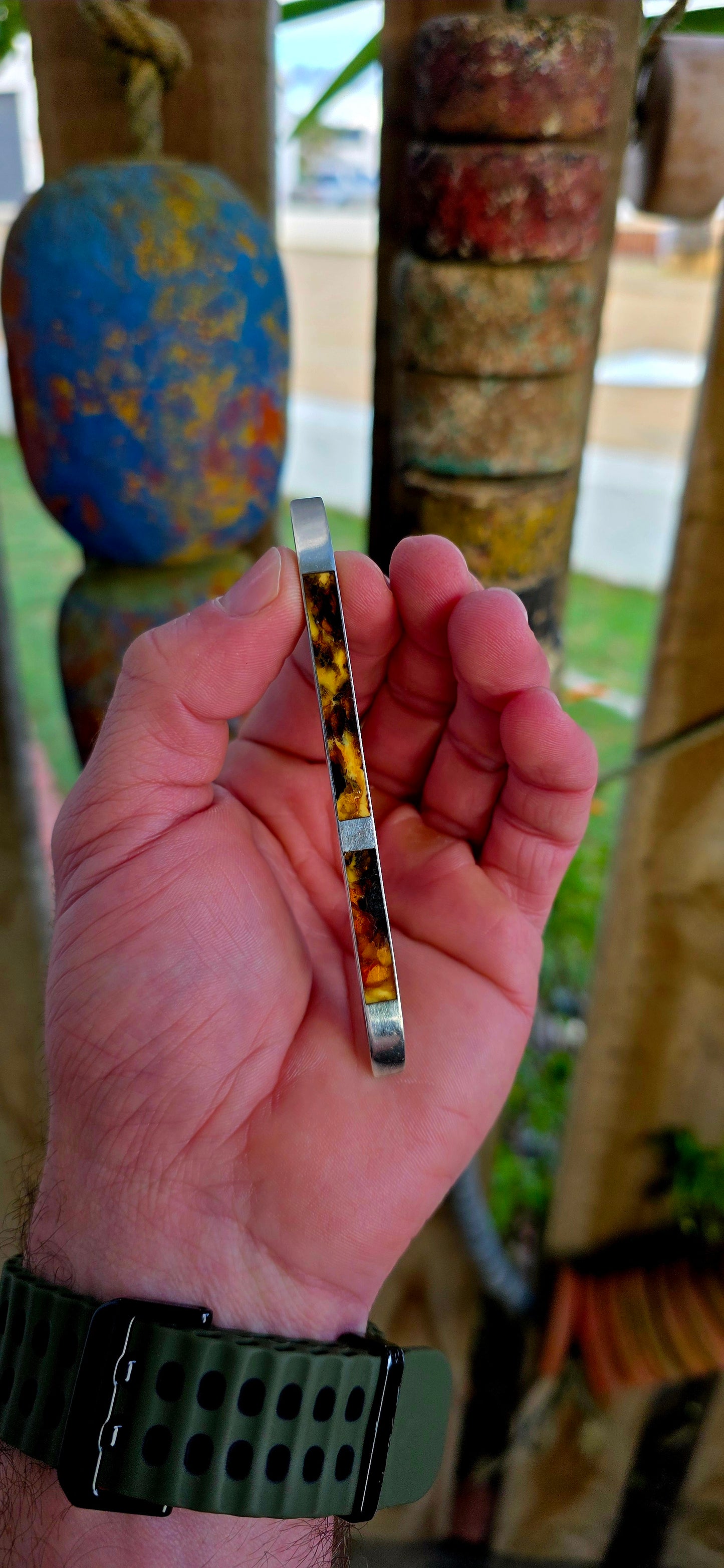This circa 1940’s modernist brooch is all about clean lines and bold material contrast — a sleek, elongated sterling silver bar inlaid with warm, glowing panels of genuine Baltic amber.