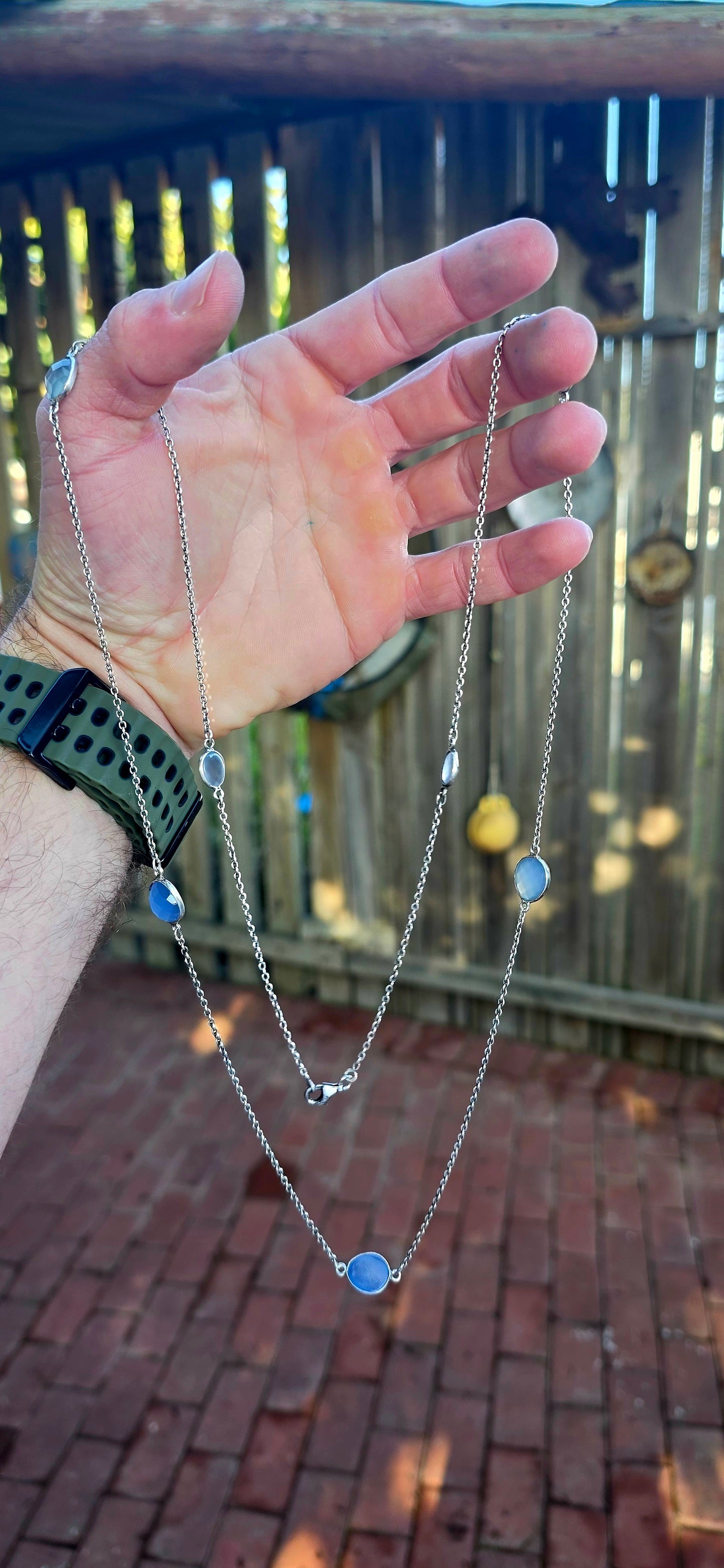 Extra-length sterling silver station-style necklace featuring a delicate scattering of faceted chalcedony gemstones gracefully suspended between fine sterling silver chain links.