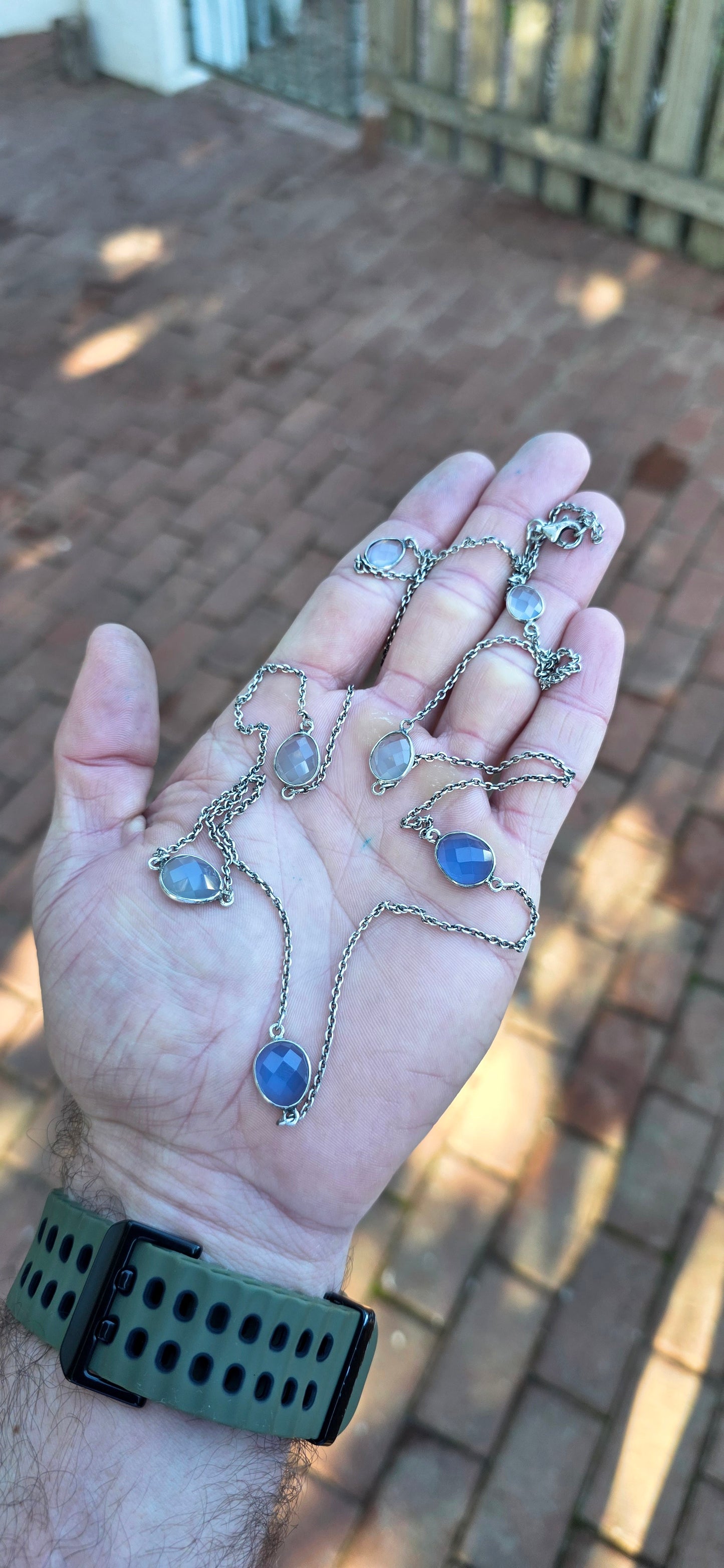 Extra-length sterling silver station-style necklace featuring a delicate scattering of faceted chalcedony gemstones gracefully suspended between fine sterling silver chain links.