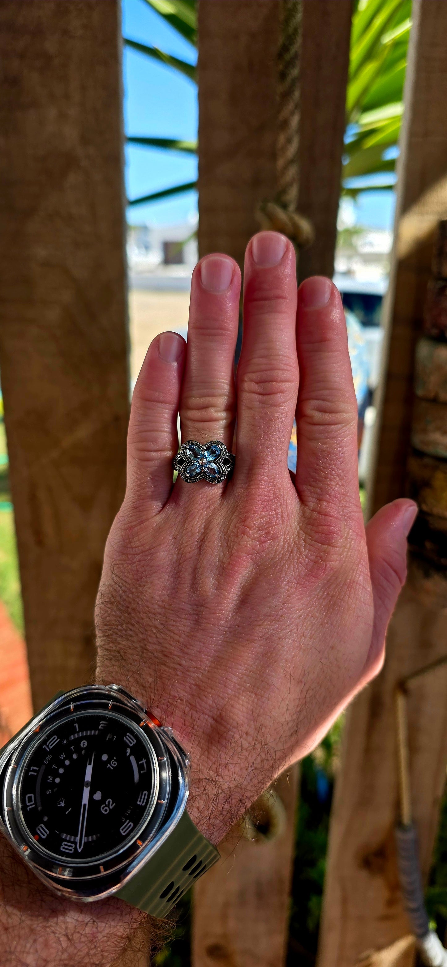 Enchanting sterling silver vintage revival dress ring featuring four pear-cut sky blue topaz gemstones arranged in the shape of a delicate flower.