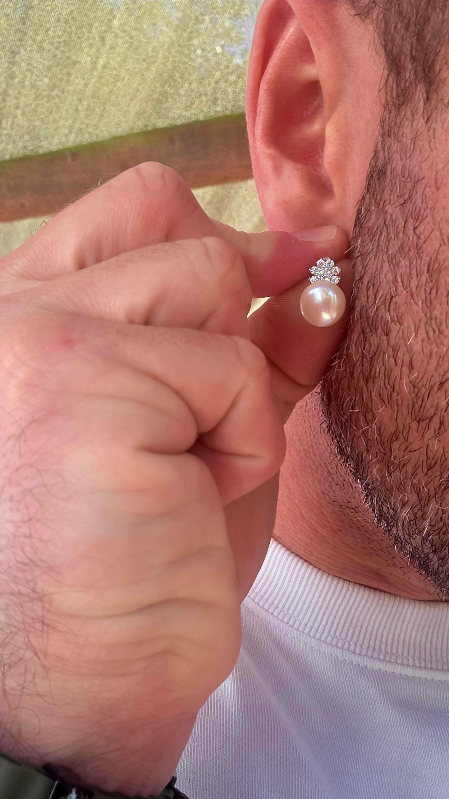 Beautiful luminous freshwater pearl stud earrings topped with delicate little crown motifs, each prong-set with sparkling round-cut cubic zirconia gemstones.