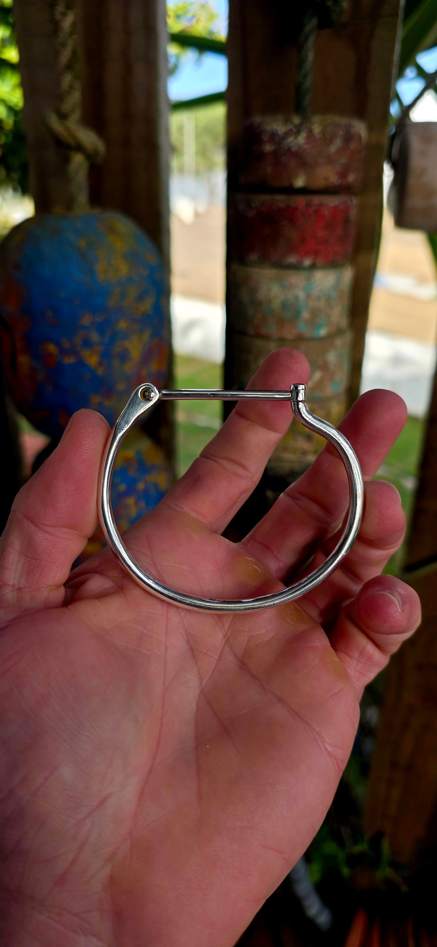 Striking sterling silver unisex tube bangle bracelet featuring a wonderfully clean and sculptural silhouette with a sleek rounded tubular design.