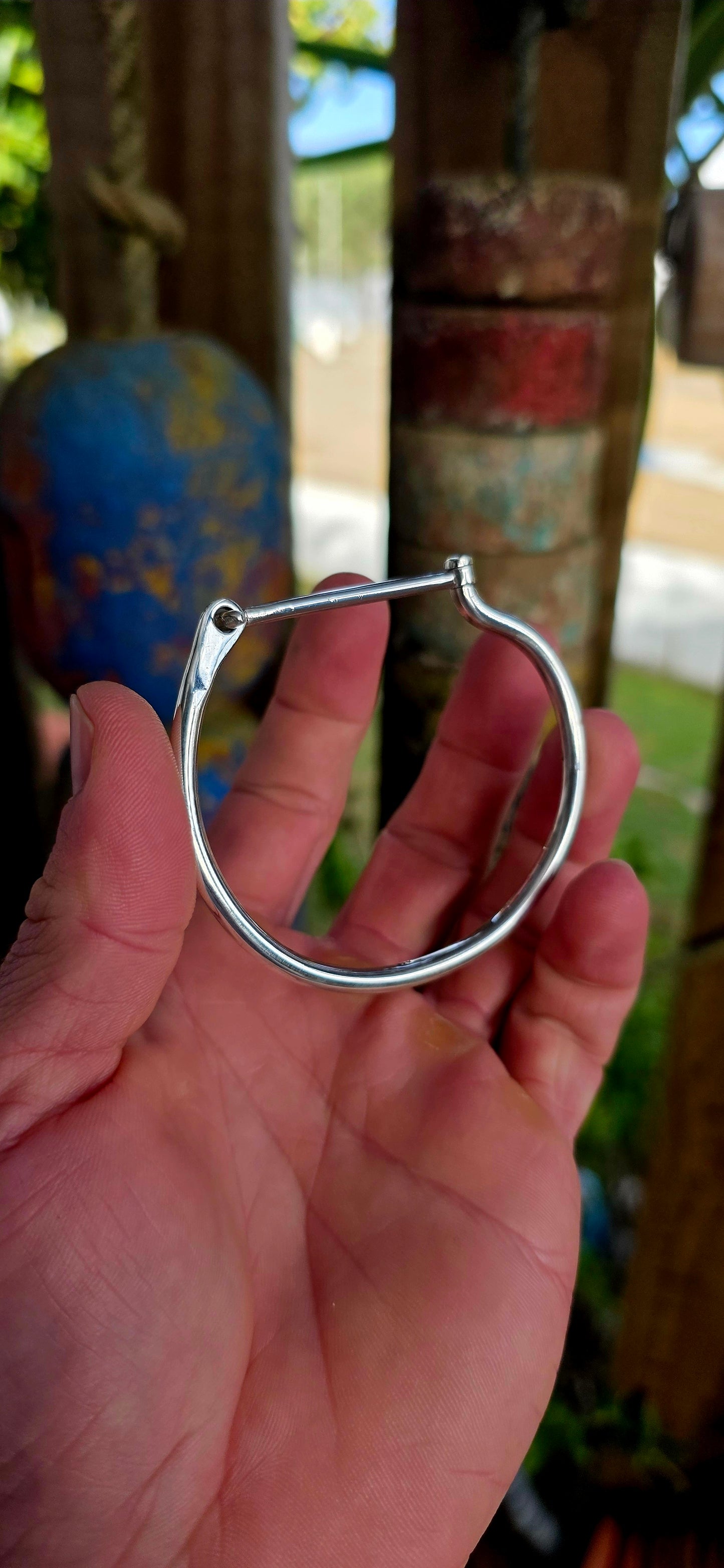 Striking sterling silver unisex tube bangle bracelet featuring a wonderfully clean and sculptural silhouette with a sleek rounded tubular design.