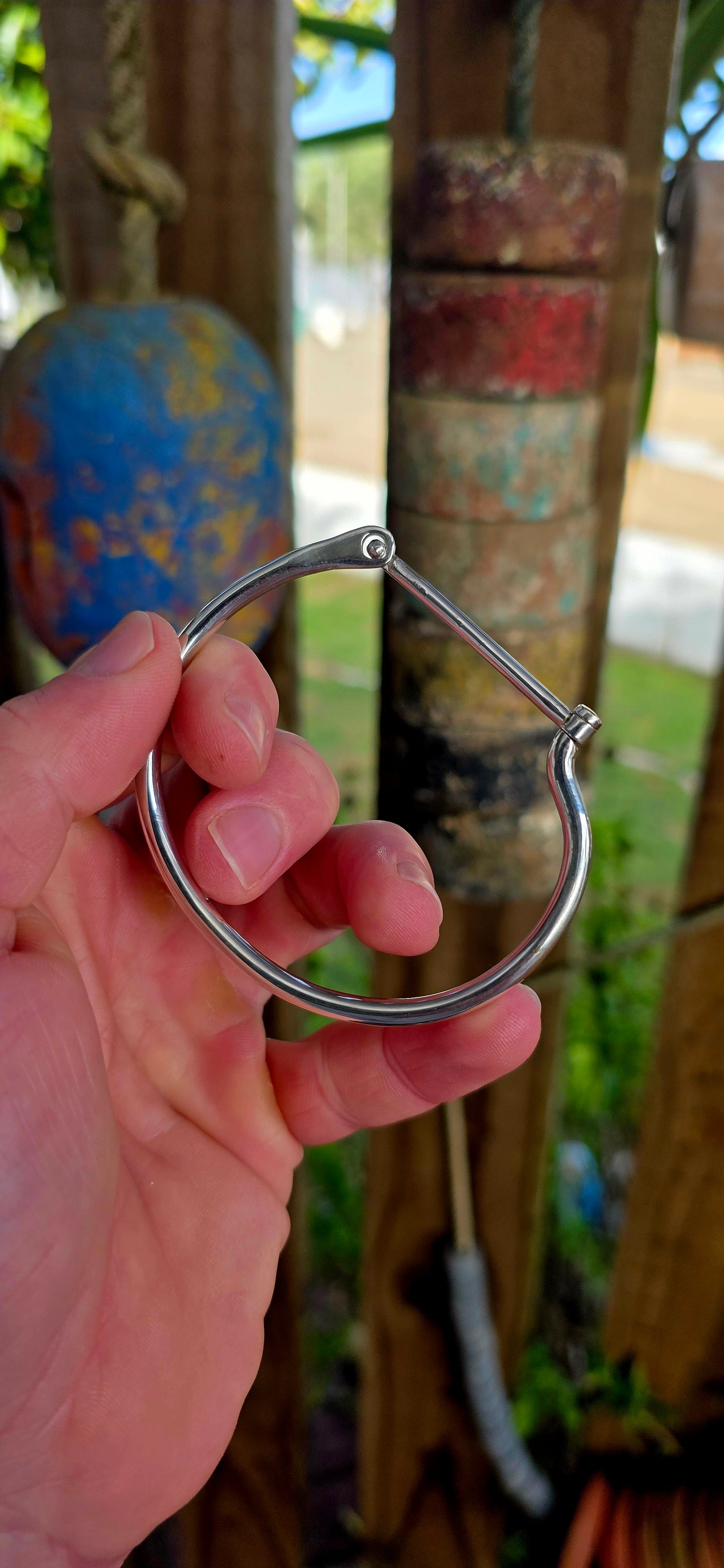 Striking sterling silver unisex tube bangle bracelet featuring a wonderfully clean and sculptural silhouette with a sleek rounded tubular design.