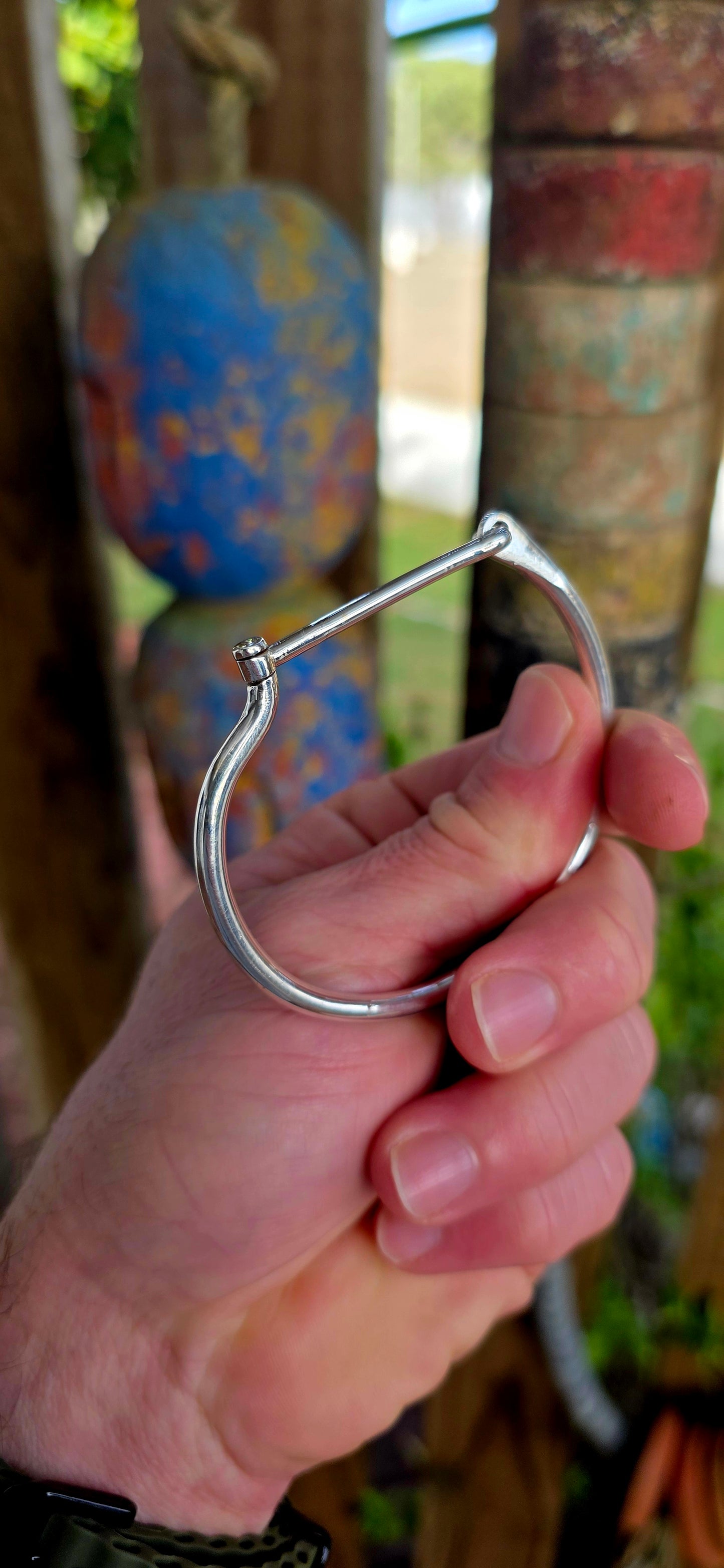 Striking sterling silver unisex tube bangle bracelet featuring a wonderfully clean and sculptural silhouette with a sleek rounded tubular design.