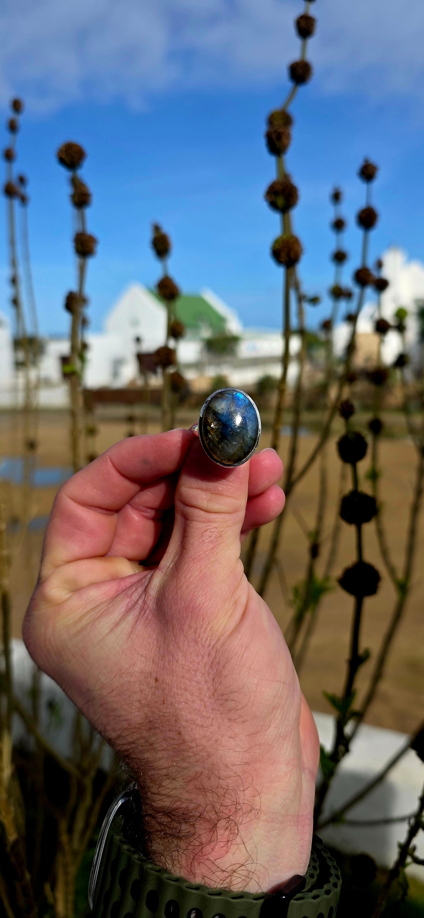 Beautiful sterling silver statement dress ring featuring a generously sized oval-cut labradorite cabochon in a sleek tube/bezel setting.