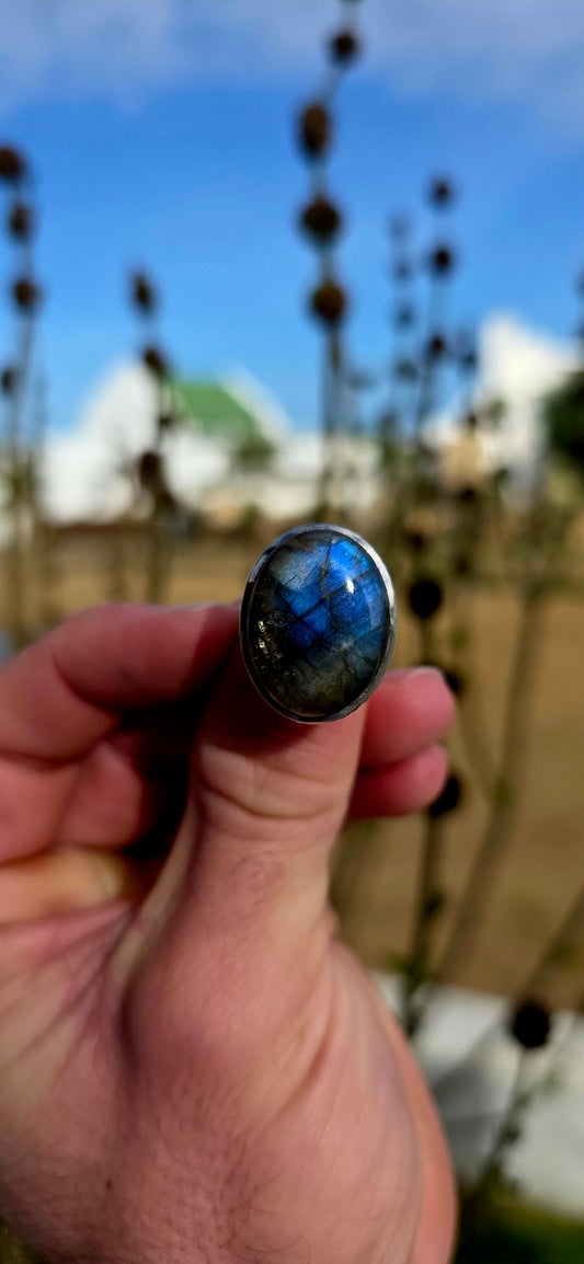 Beautiful sterling silver statement dress ring featuring a generously sized oval-cut labradorite cabochon in a sleek tube/bezel setting.