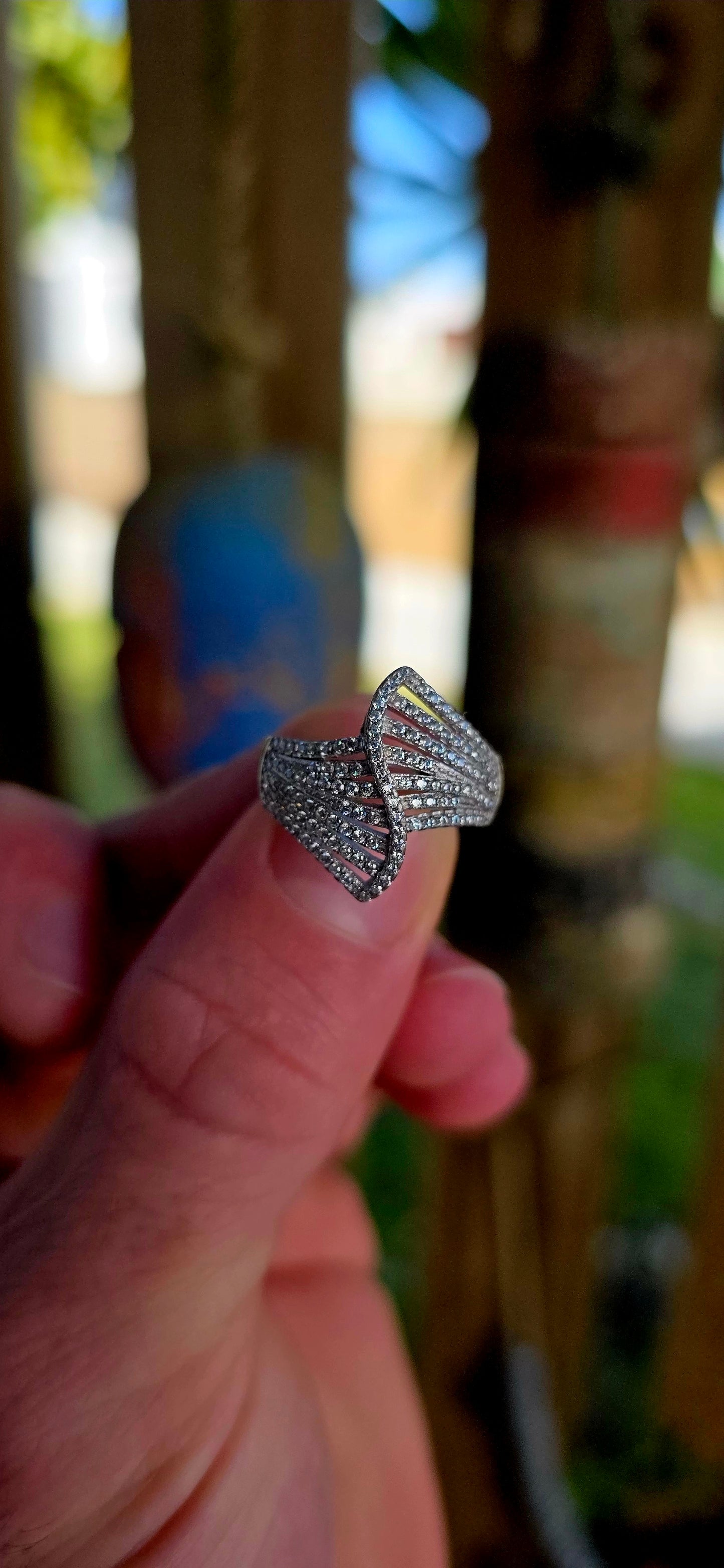 Sterling silver Art Deco revival bypass dress ring featuring a dramatic pierced fan/ribbon-inspired design entirely pavé set with rows of tiny sparkly cubic zirconia gemstones.