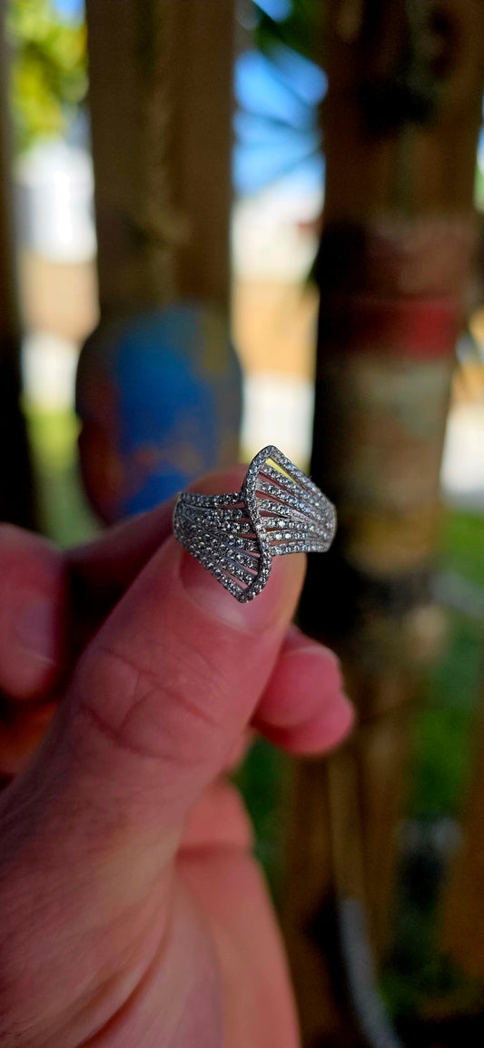 Sterling silver Art Deco revival bypass dress ring featuring a dramatic pierced fan/ribbon-inspired design entirely pavé set with rows of tiny sparkly cubic zirconia gemstones.