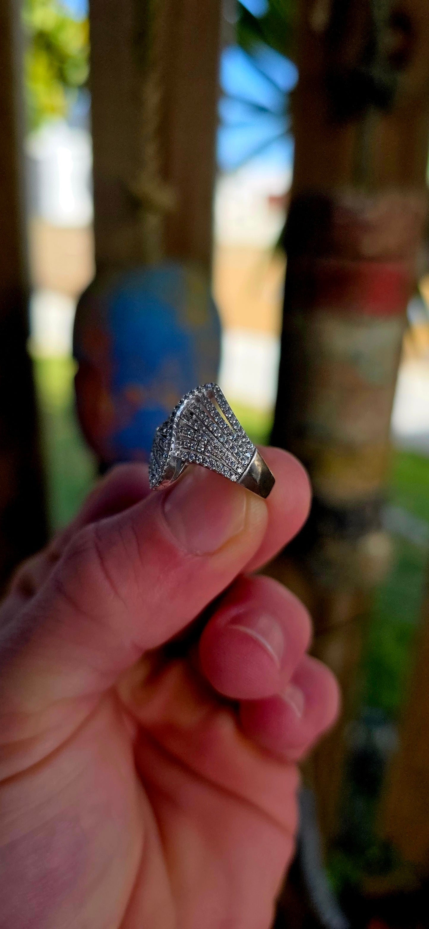 Sterling silver Art Deco revival bypass dress ring featuring a dramatic pierced fan/ribbon-inspired design entirely pavé set with rows of tiny sparkly cubic zirconia gemstones.
