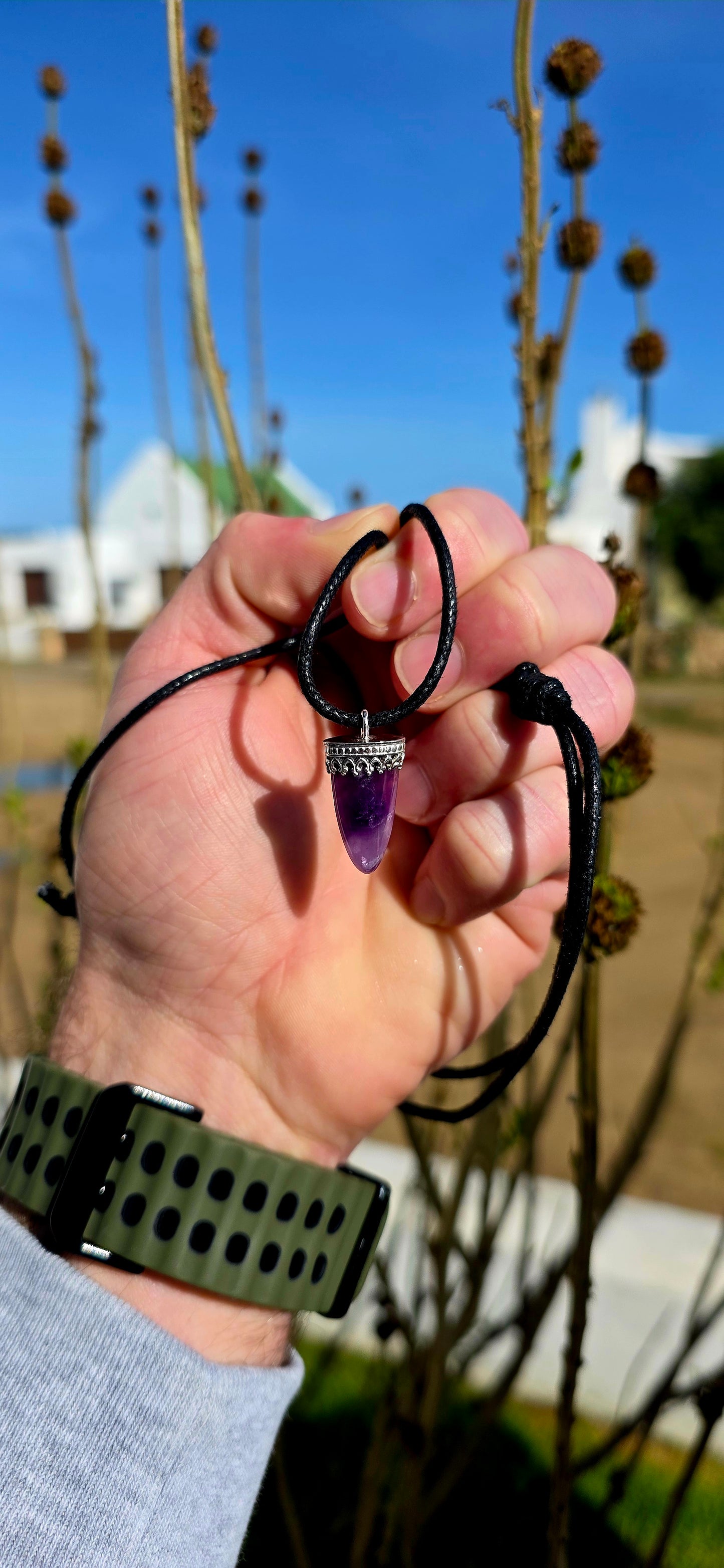 Earthy, mystical and wonderfully organic — this artisan-made unisex talisman necklace features a polished freeform amethyst shard in a beautifully tapered claw/tooth-inspired shape.