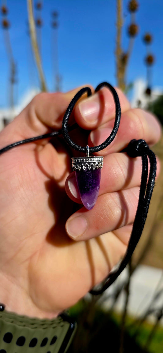 Earthy, mystical and wonderfully organic — this artisan-made unisex talisman necklace features a polished freeform amethyst shard in a beautifully tapered claw/tooth-inspired shape.