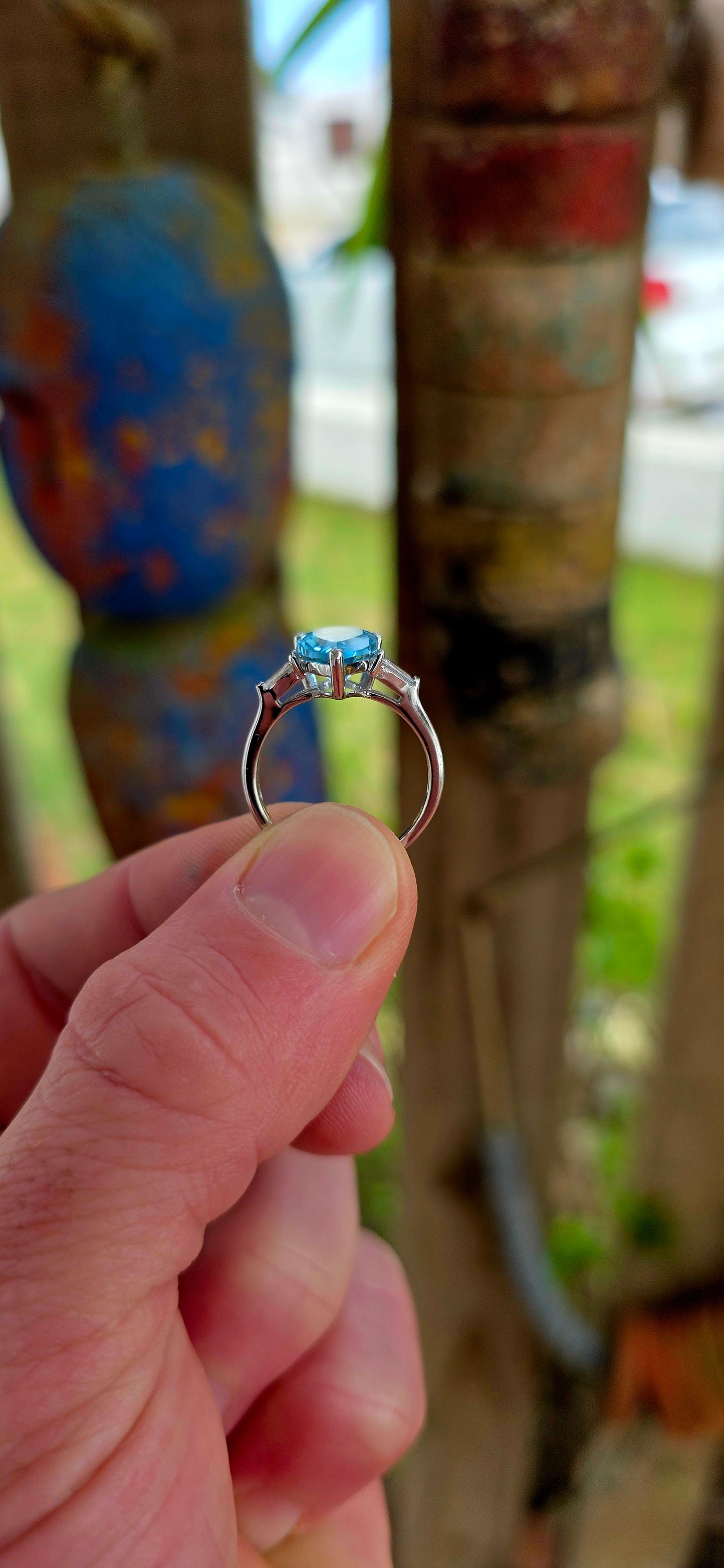 This elegant Art Deco revival trilogy ring is crafted in sterling silver and crowned with a generously sized pear-cut Swiss blue topaz in a classic prong setting.