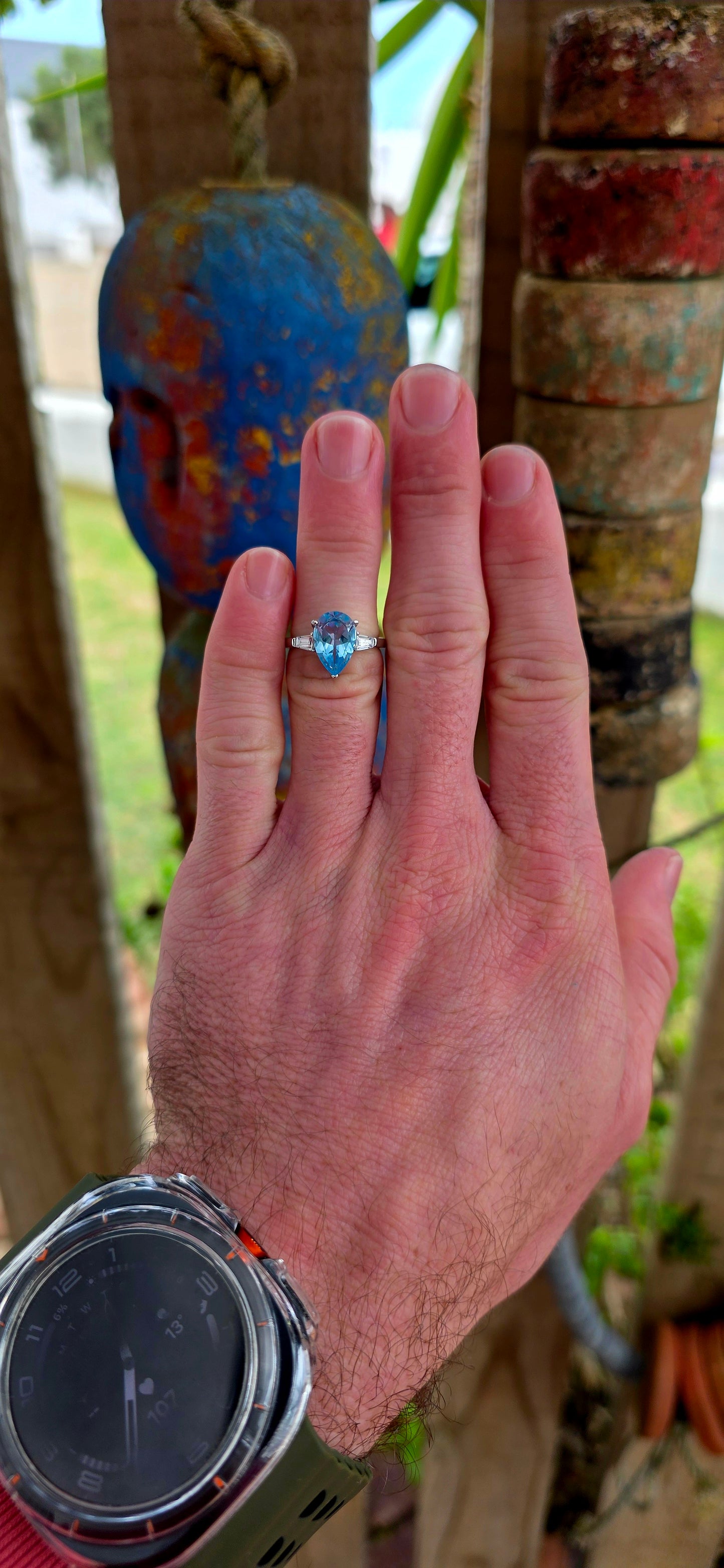 This elegant Art Deco revival trilogy ring is crafted in sterling silver and crowned with a generously sized pear-cut Swiss blue topaz in a classic prong setting.