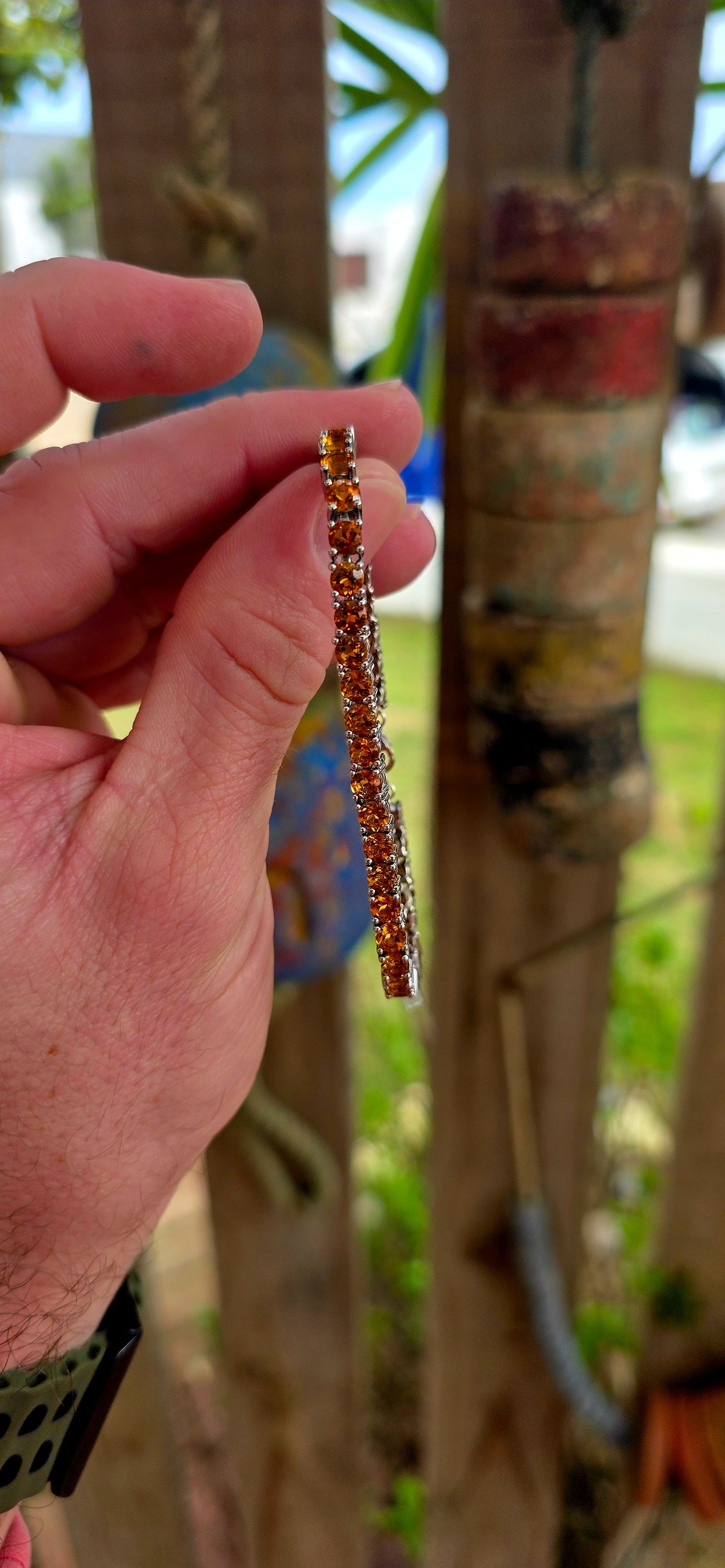 This beautiful sterling silver tennis bracelet features an elegant line-up of 37 vibrant orangy-citrine gemstones, each delicately prong set.