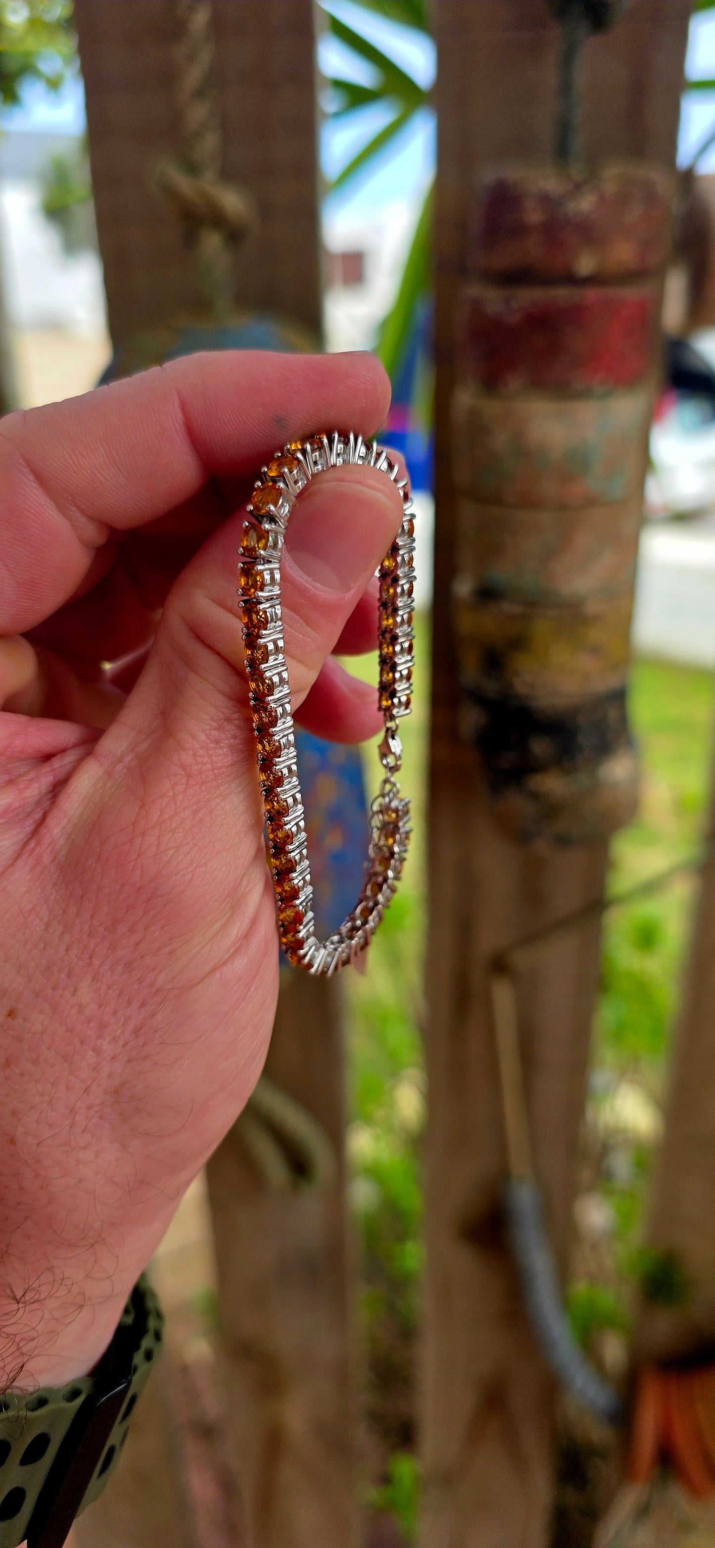 This beautiful sterling silver tennis bracelet features an elegant line-up of 37 vibrant orangy-citrine gemstones, each delicately prong set.