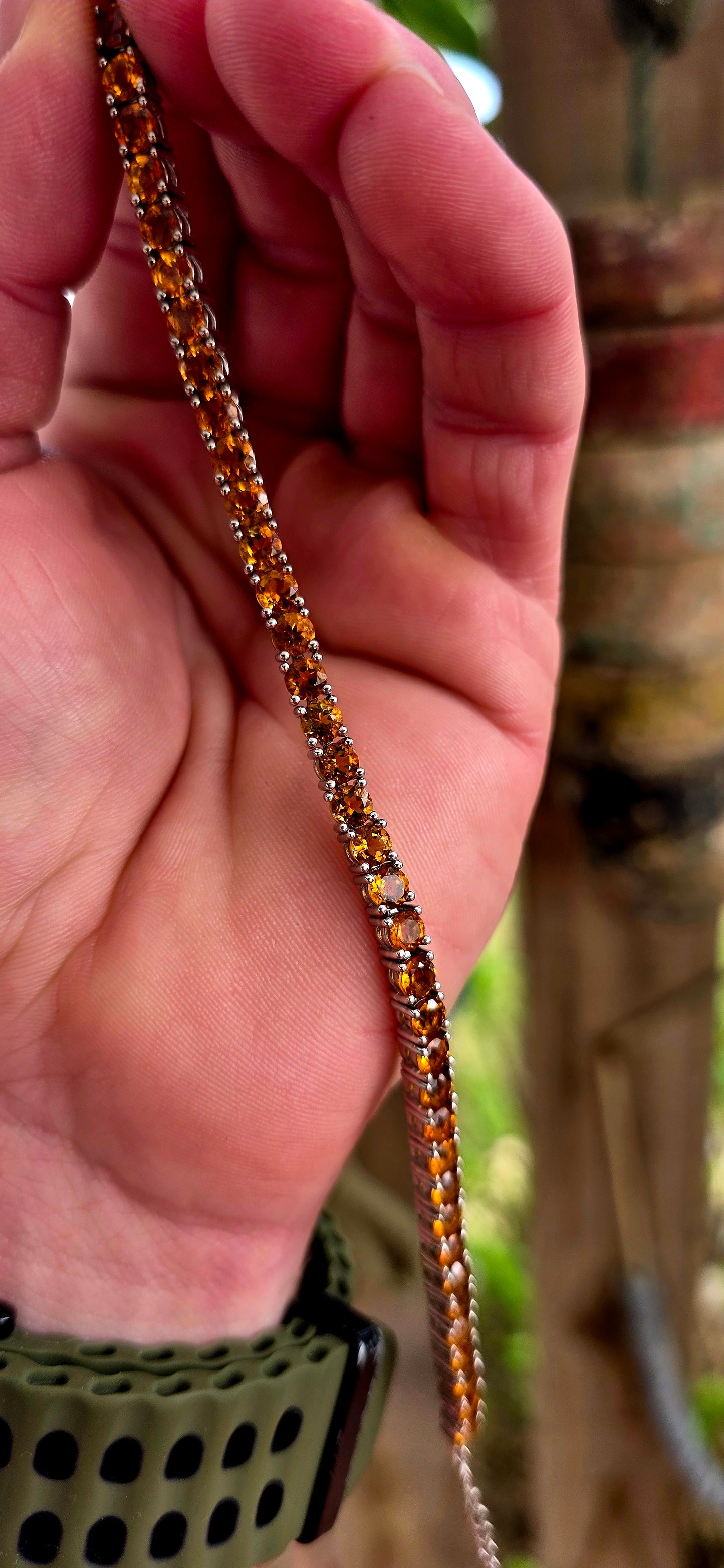 This beautiful sterling silver tennis bracelet features an elegant line-up of 37 vibrant orangy-citrine gemstones, each delicately prong set.