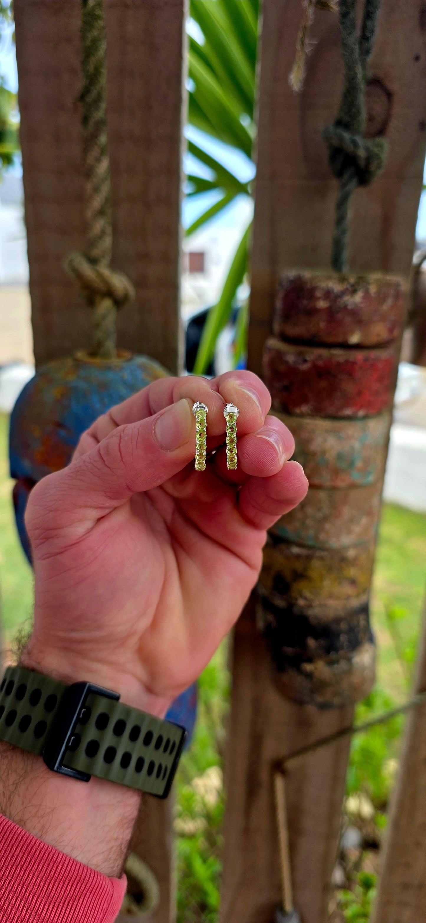 These beautiful sterling silver half hoop “J” shaped earrings are prong set with a shimmering line-up of round-cut peridot gemstones, glowing in vibrant shades of fresh lime, apple green, and soft golden-green sparkle.